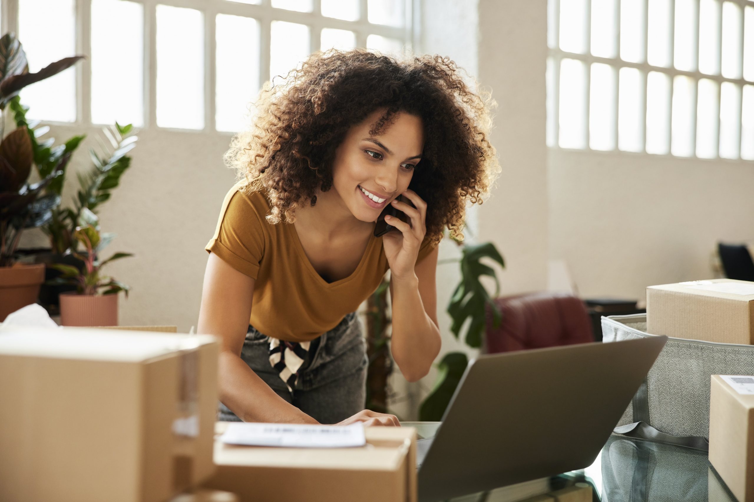 woman on the phone using laptop