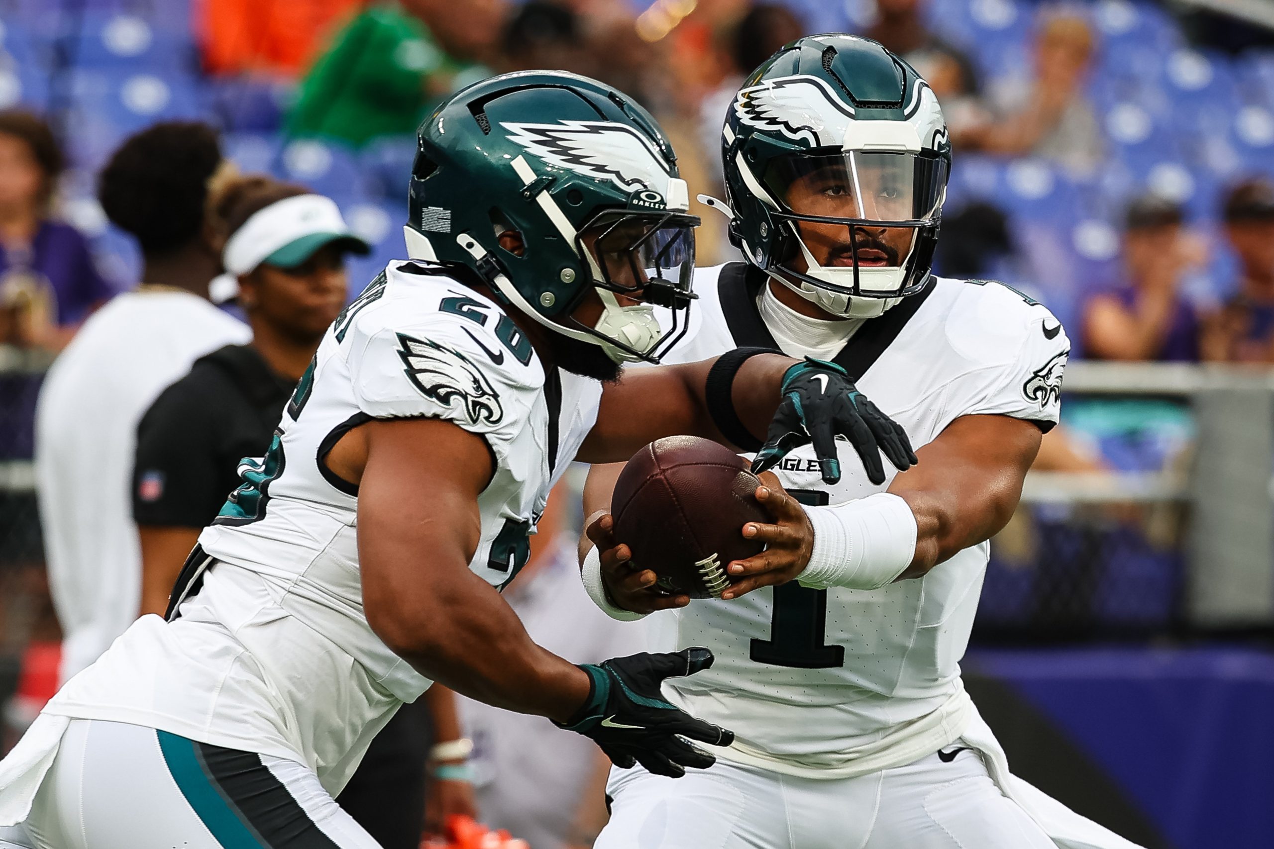 Jalen Hurts of the Philadelphia Eagles hands the ball off