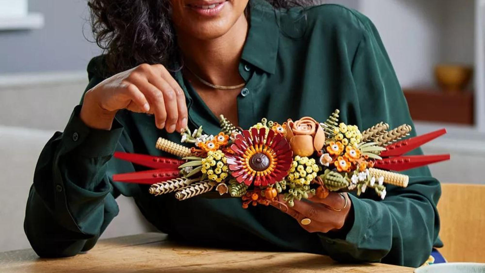 woman building Lego dried flower centerpiece kit