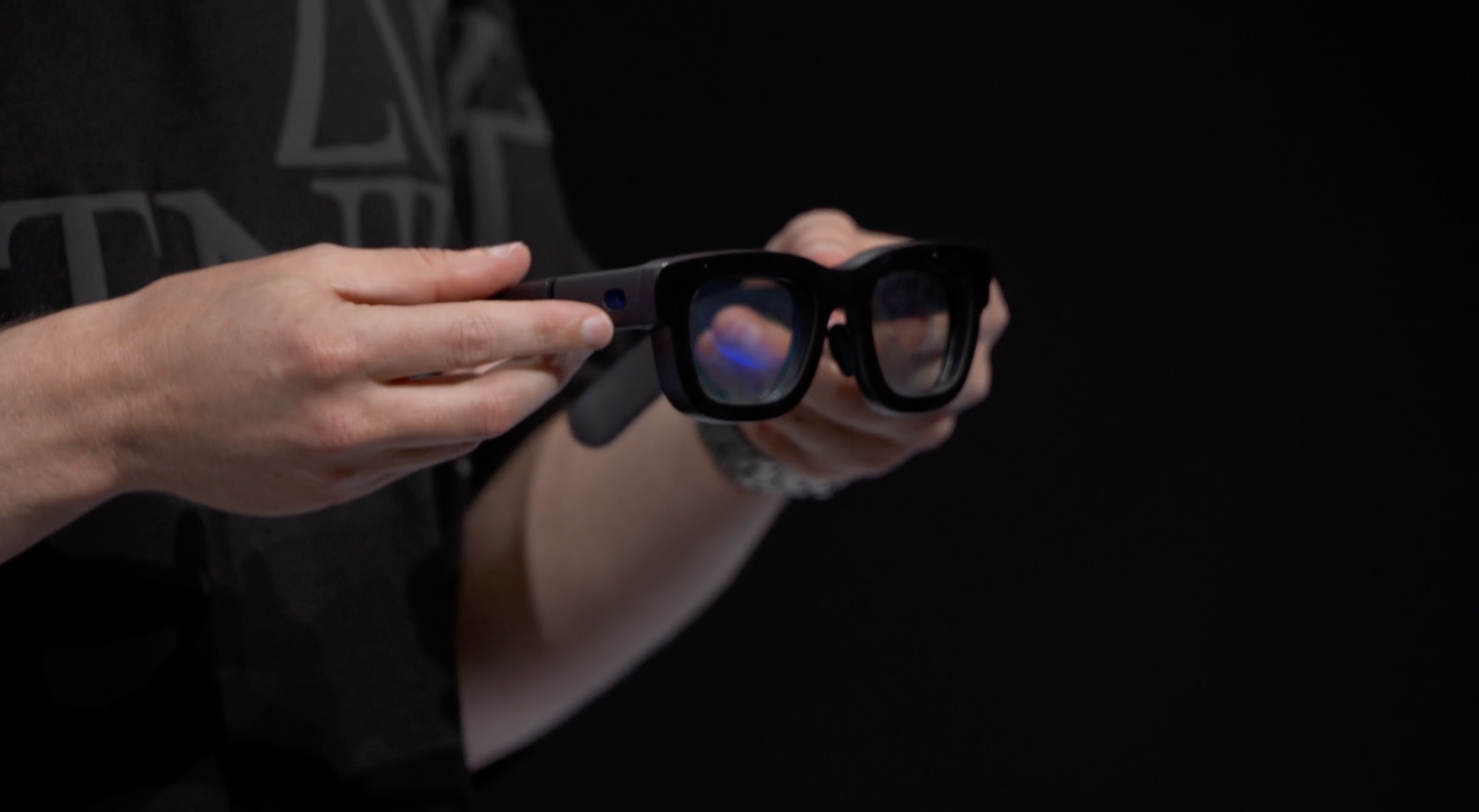 Pair of augemented glasses being held by hands