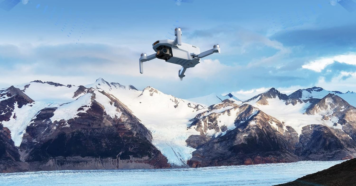 Potensic drone flying above snowy mountain tops 