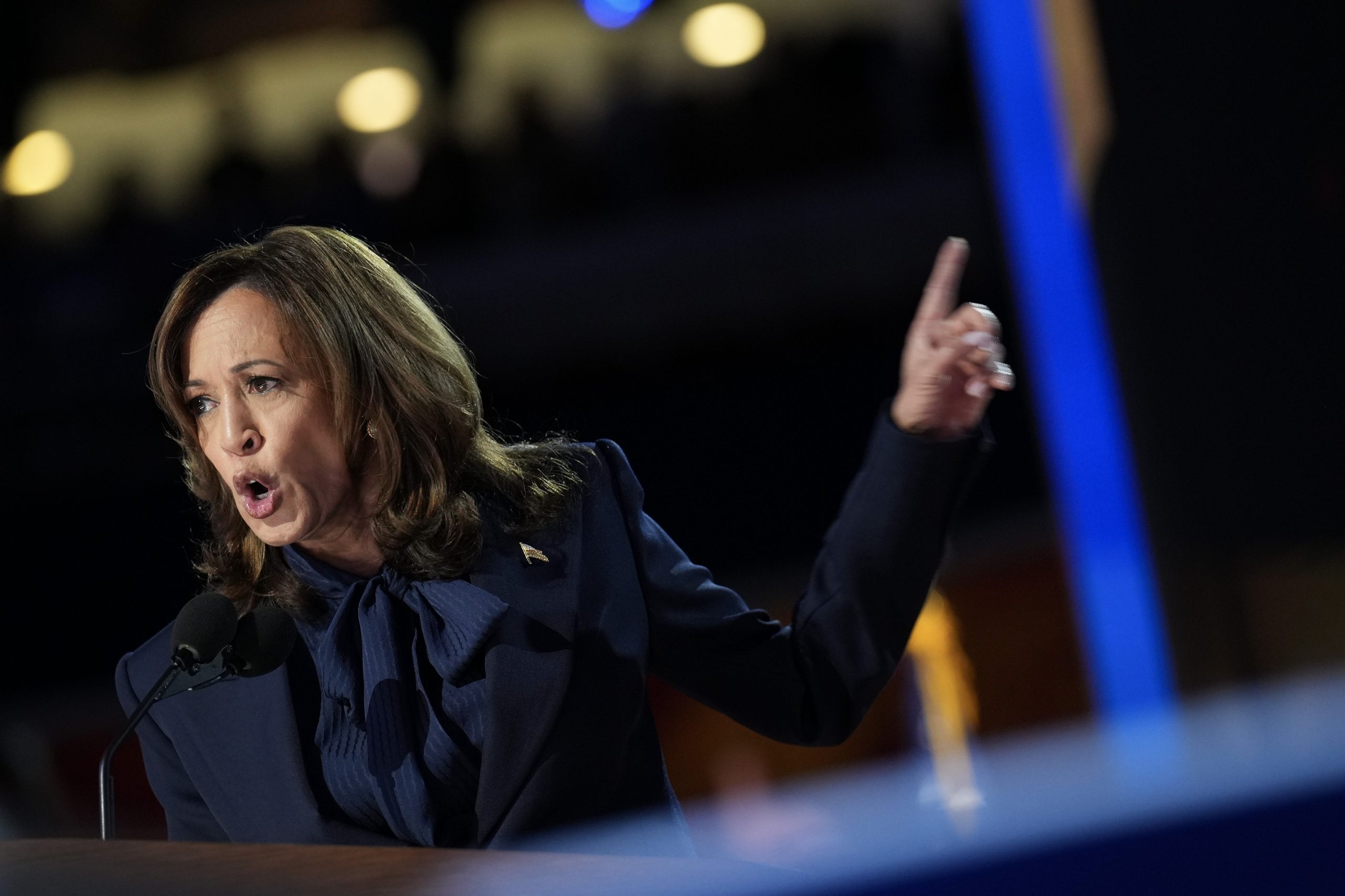 Kamala Harris speaking enthusiastically at the DNC podium.