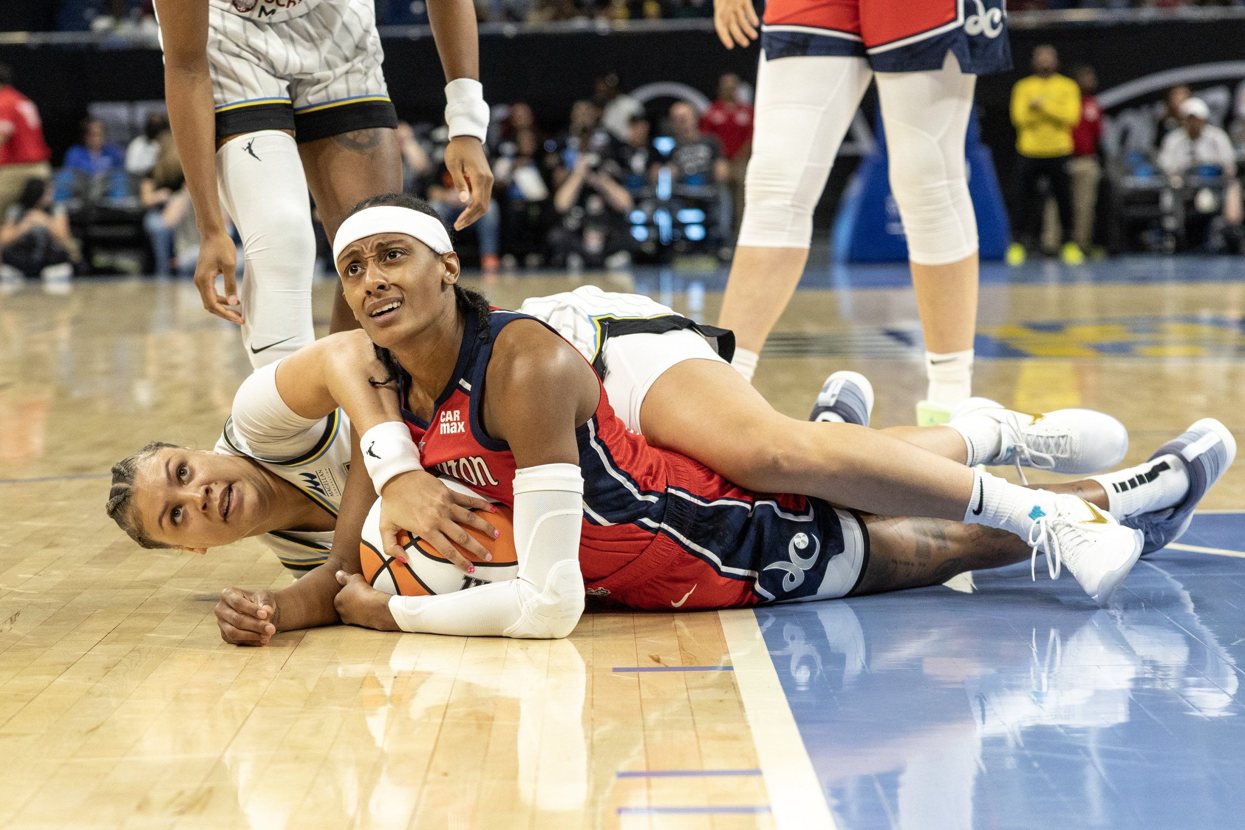 Brittney Sykes of the Washington Mystics battles for a loose ball with Rachel Banham of the Chicago Sky