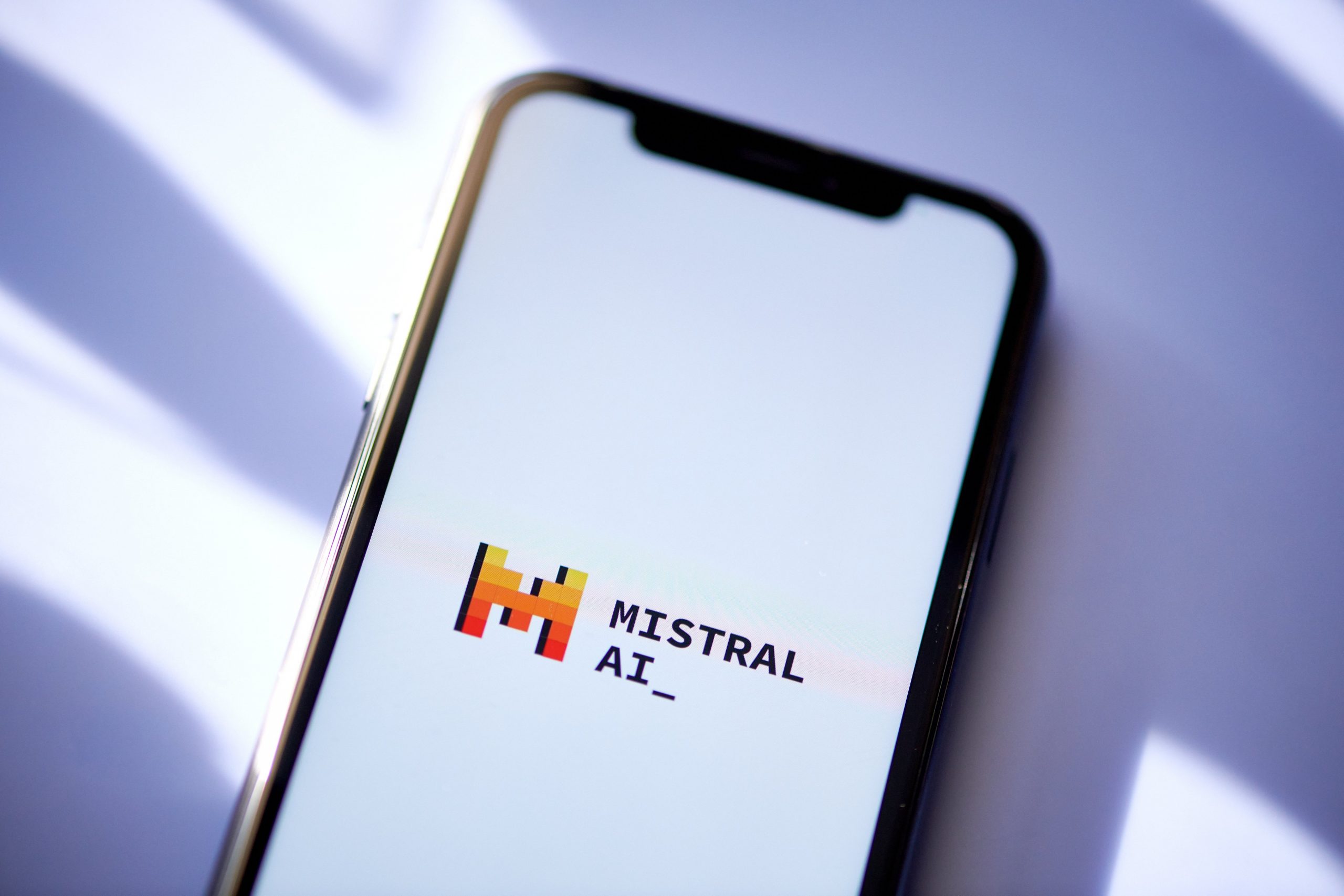 The Mistral AI logo on a smartphone