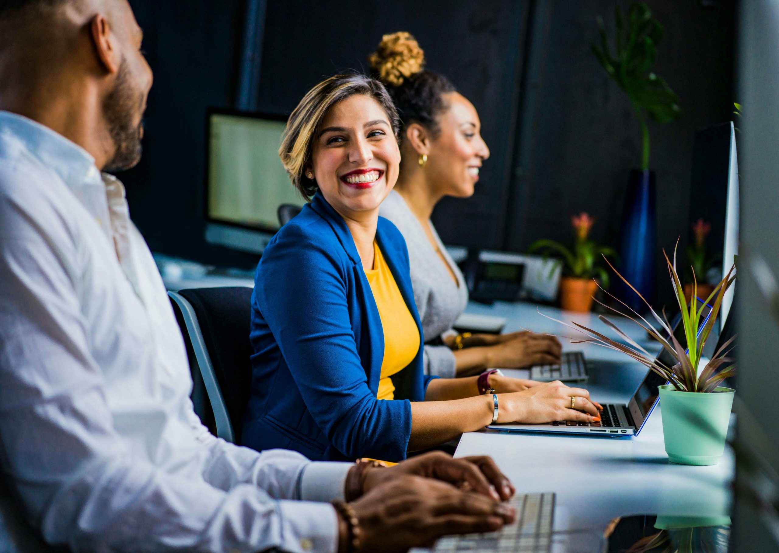 woman smiling with coworkers