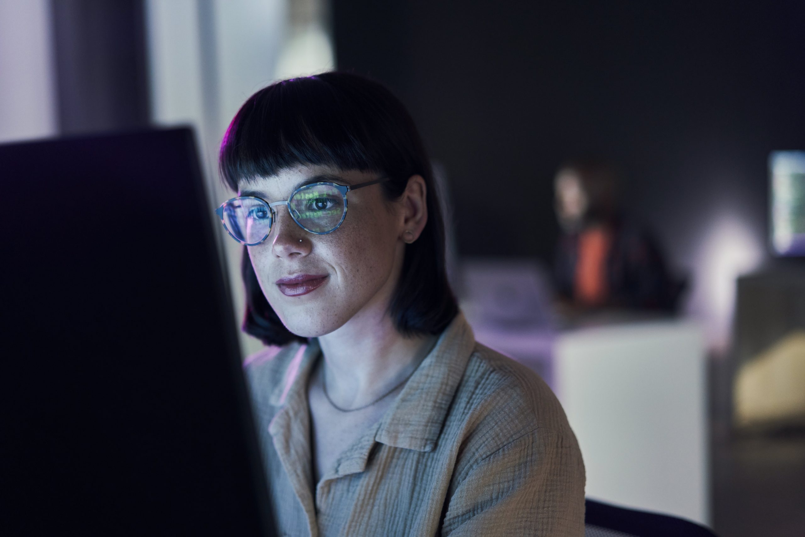 woman with glasses coding