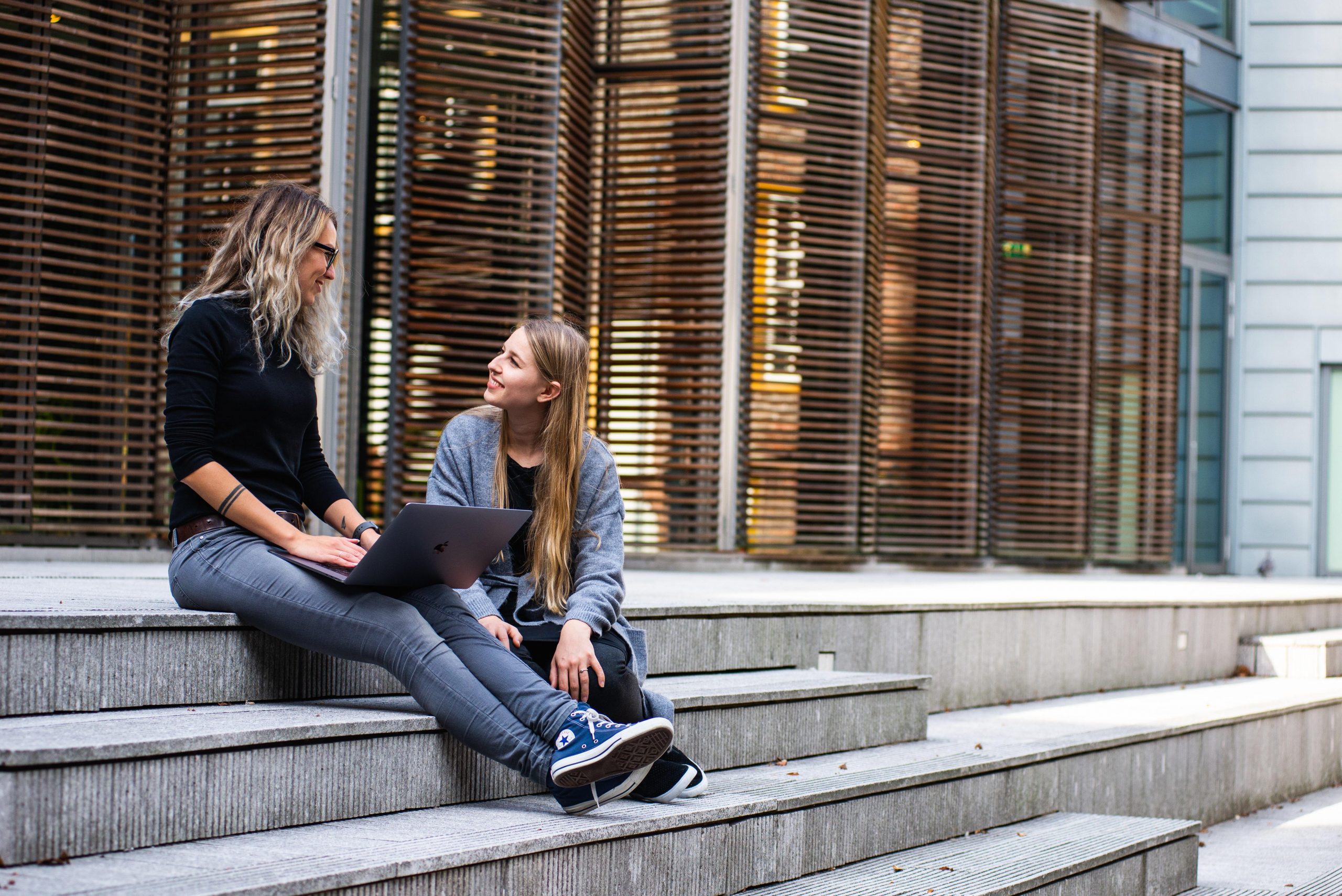 Two people talking on steps