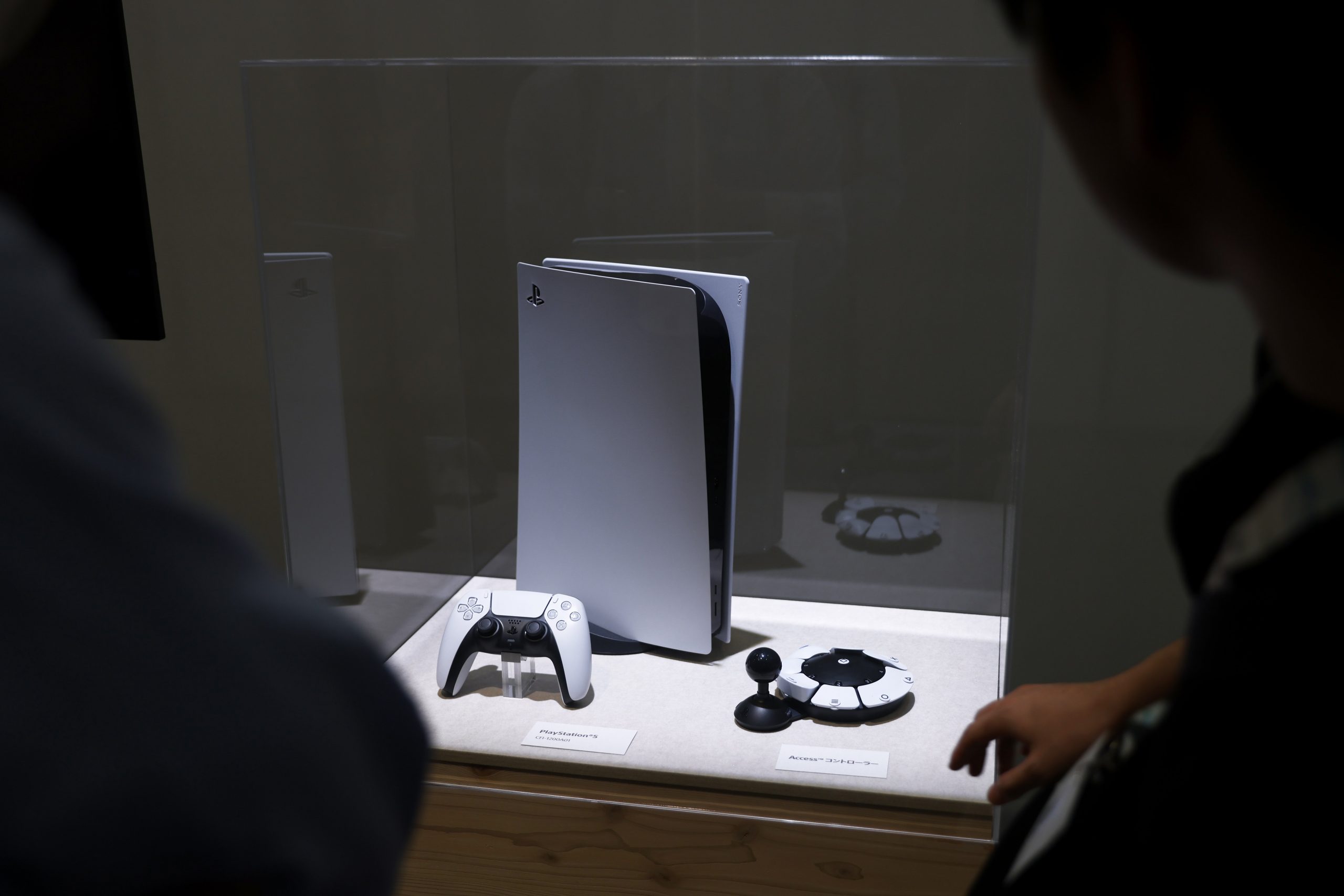 A PlayStation 5 (PS5) video game console and a controller at the Sony Group Corp. booth at the Combined Exhibition of Advanced Technologies 