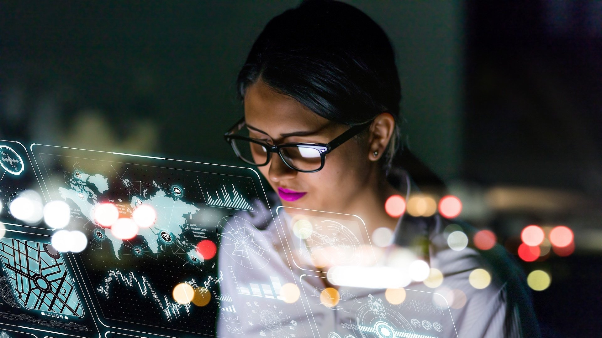 A female tech executive looking at a computer.