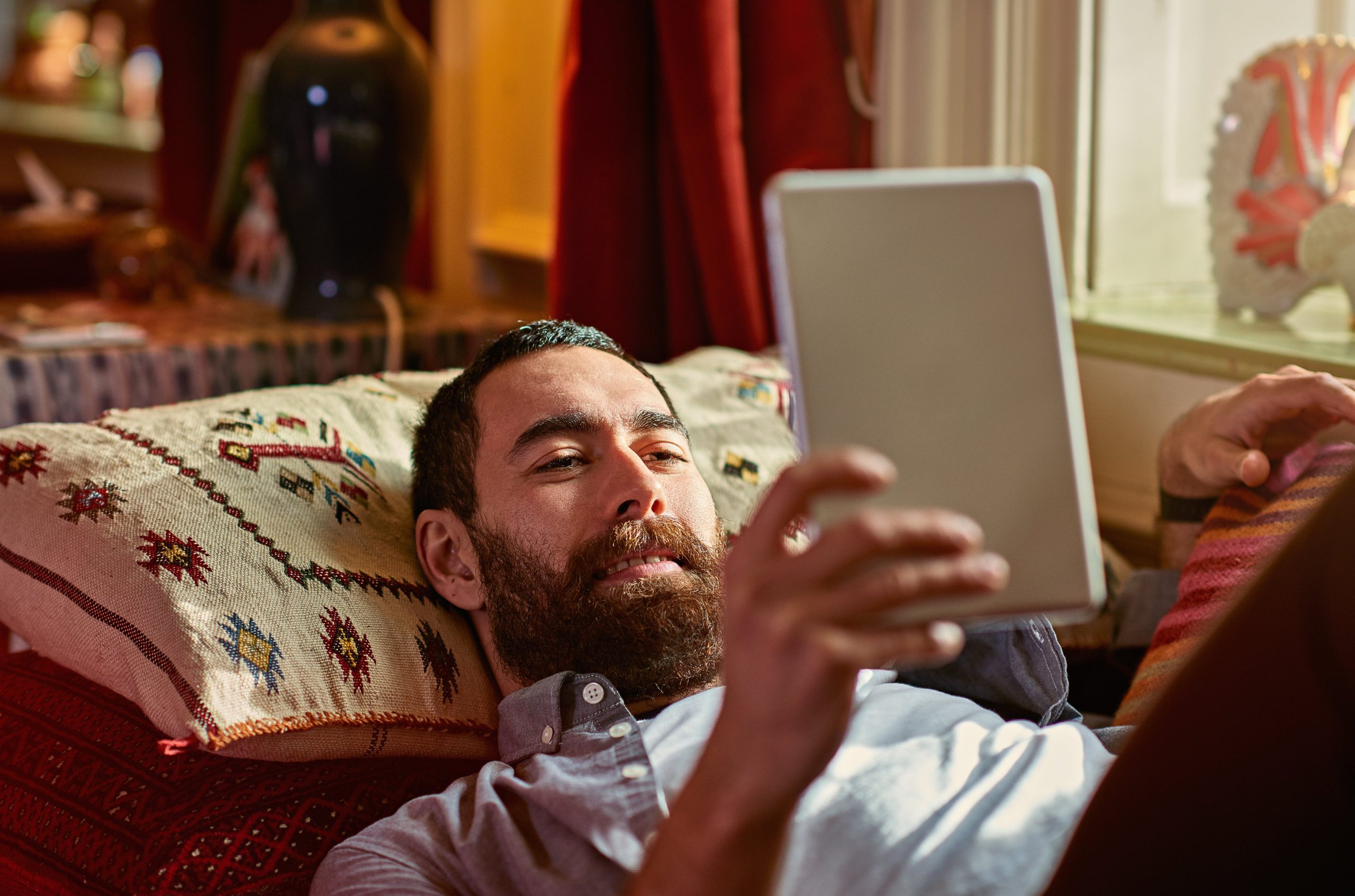 Young man relaxing with a digital tablet