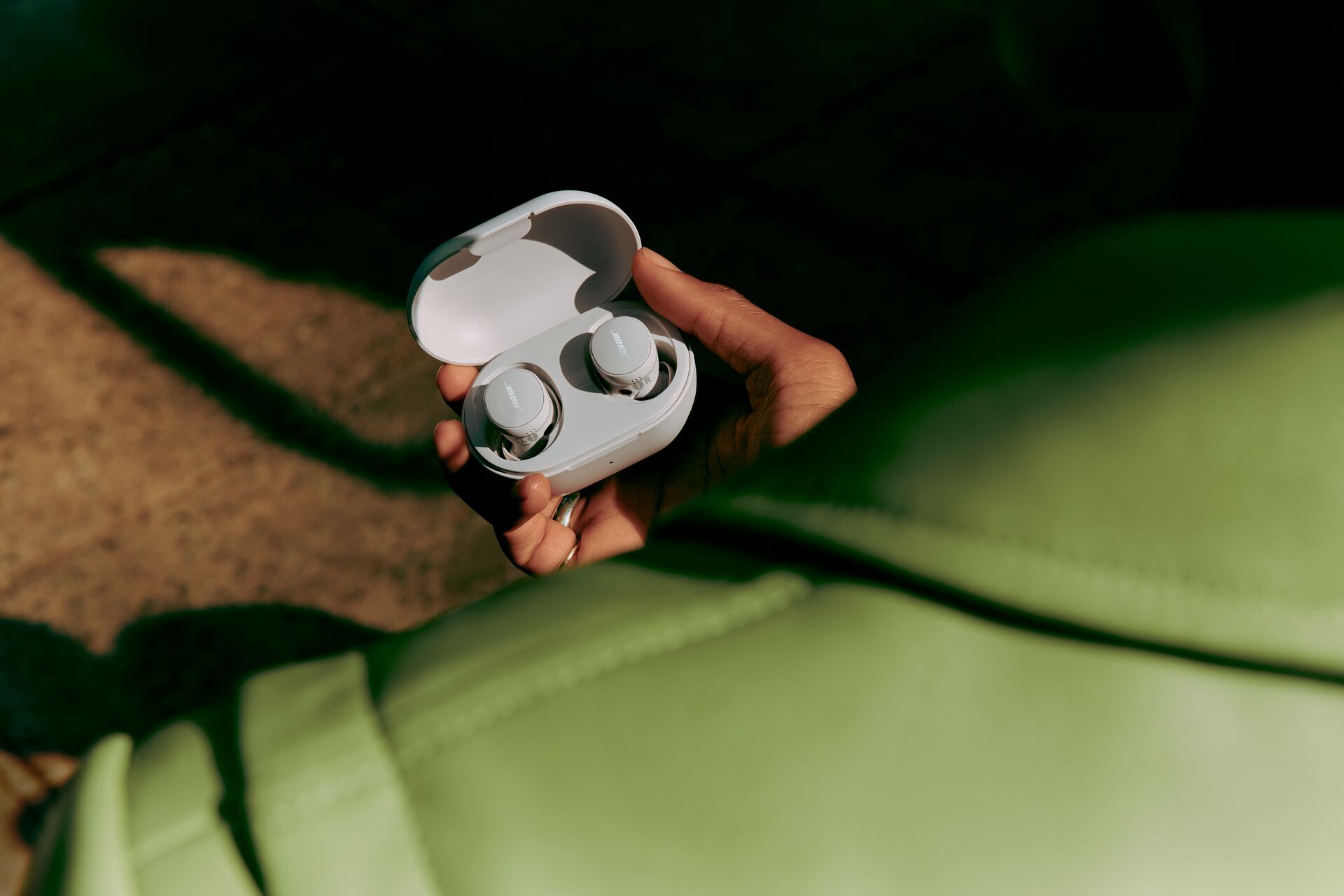 A person holding the Bose QuietComfort headphones