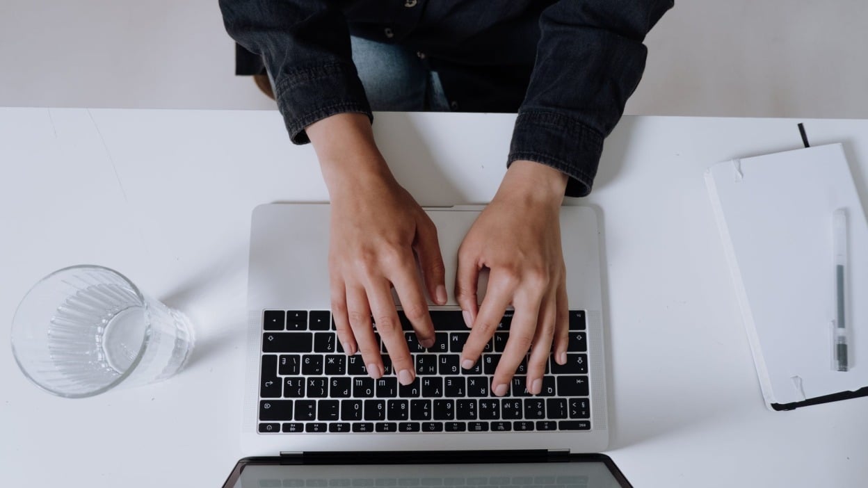 person typing on laptop