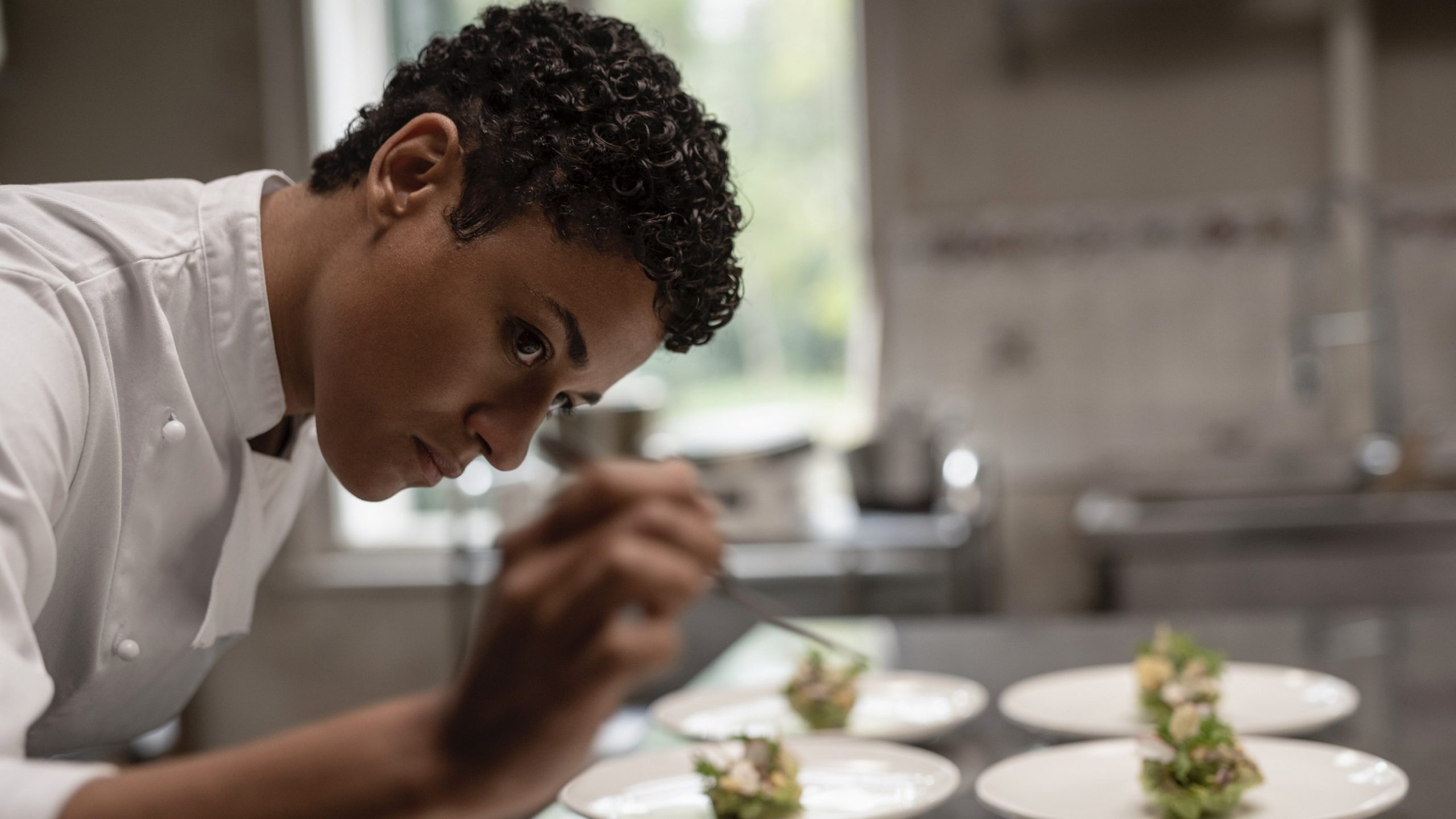 Chef puts the last finishes on her dishes.