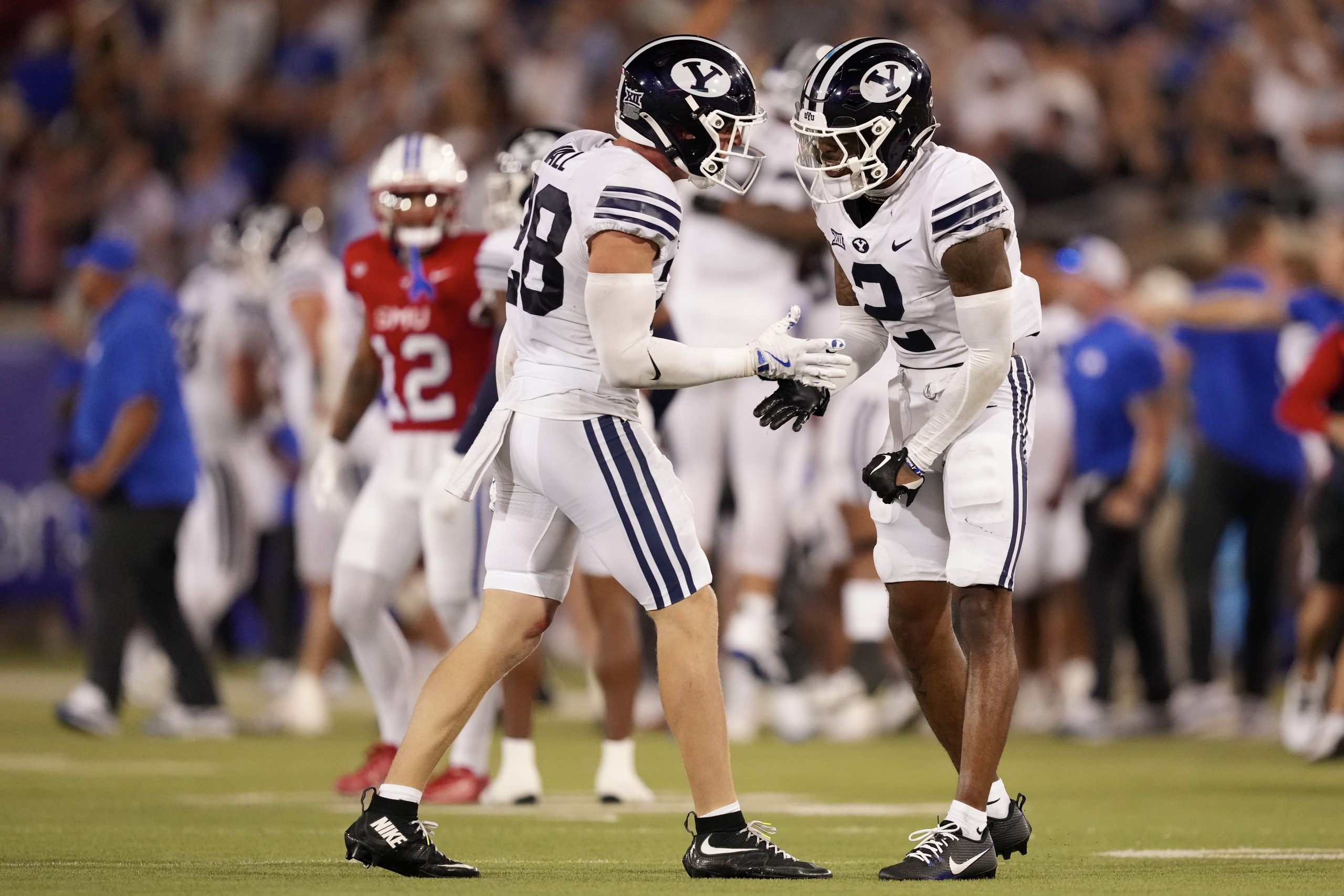 Tanner Wall #28 and Chase Roberts #2 of the Brigham Young Cougars celebrate together after a defensive stop during the second half against the Southern Methodist Mustangs at Gerald J. Ford Stadium on Sept. 6, 2024, in Dallas, Texas.