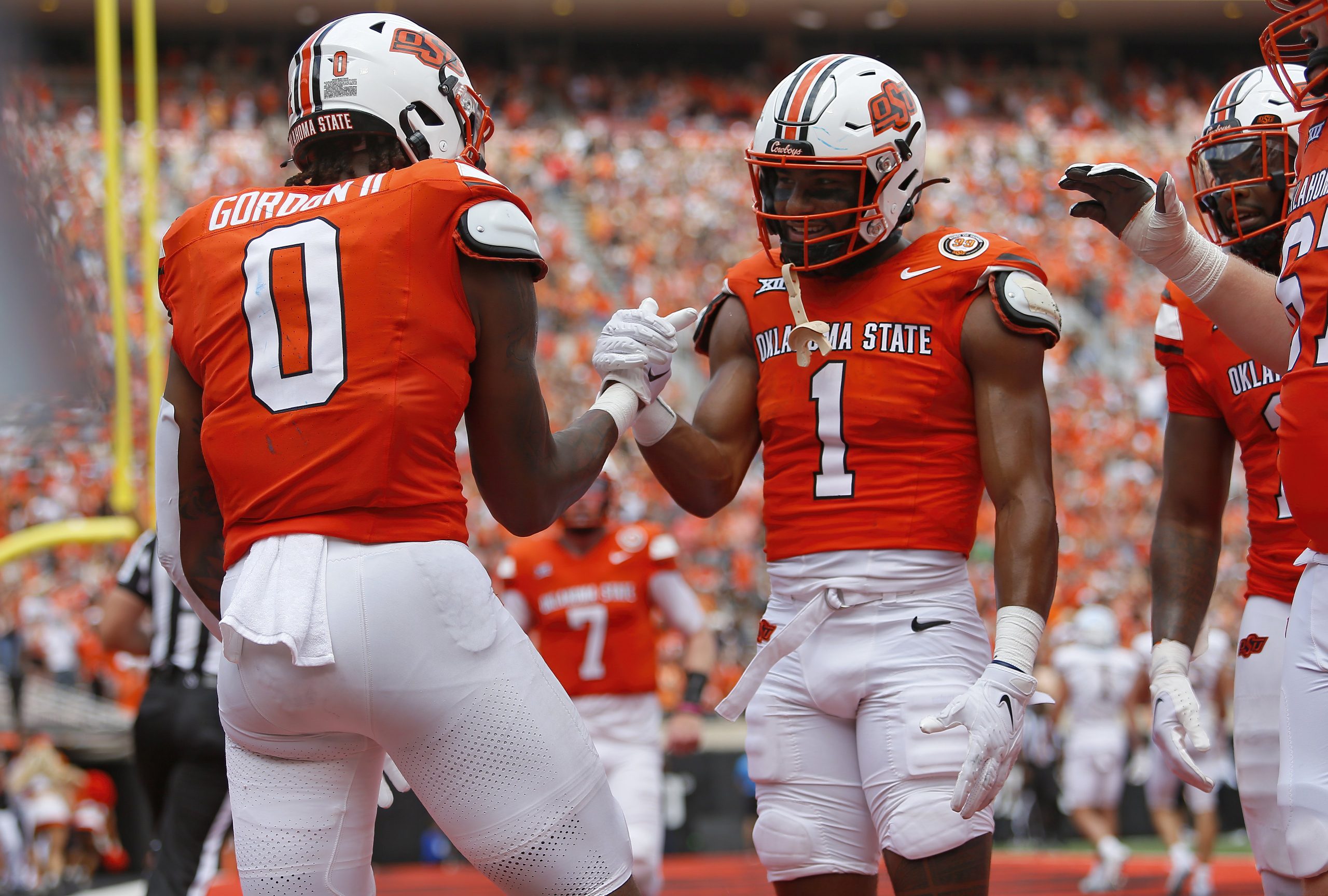 Wide receiver De'Zhaun Stribling #1 congratulates running back Ollie Gordon II #0 of the Oklahoma State Cowboys on a 12-yard touchdown against the South Dakota State Jackrabbits in the second quarter at Boone Pickens Stadium on Aug. 31, 2024, in Stillwater, Oklahoma.