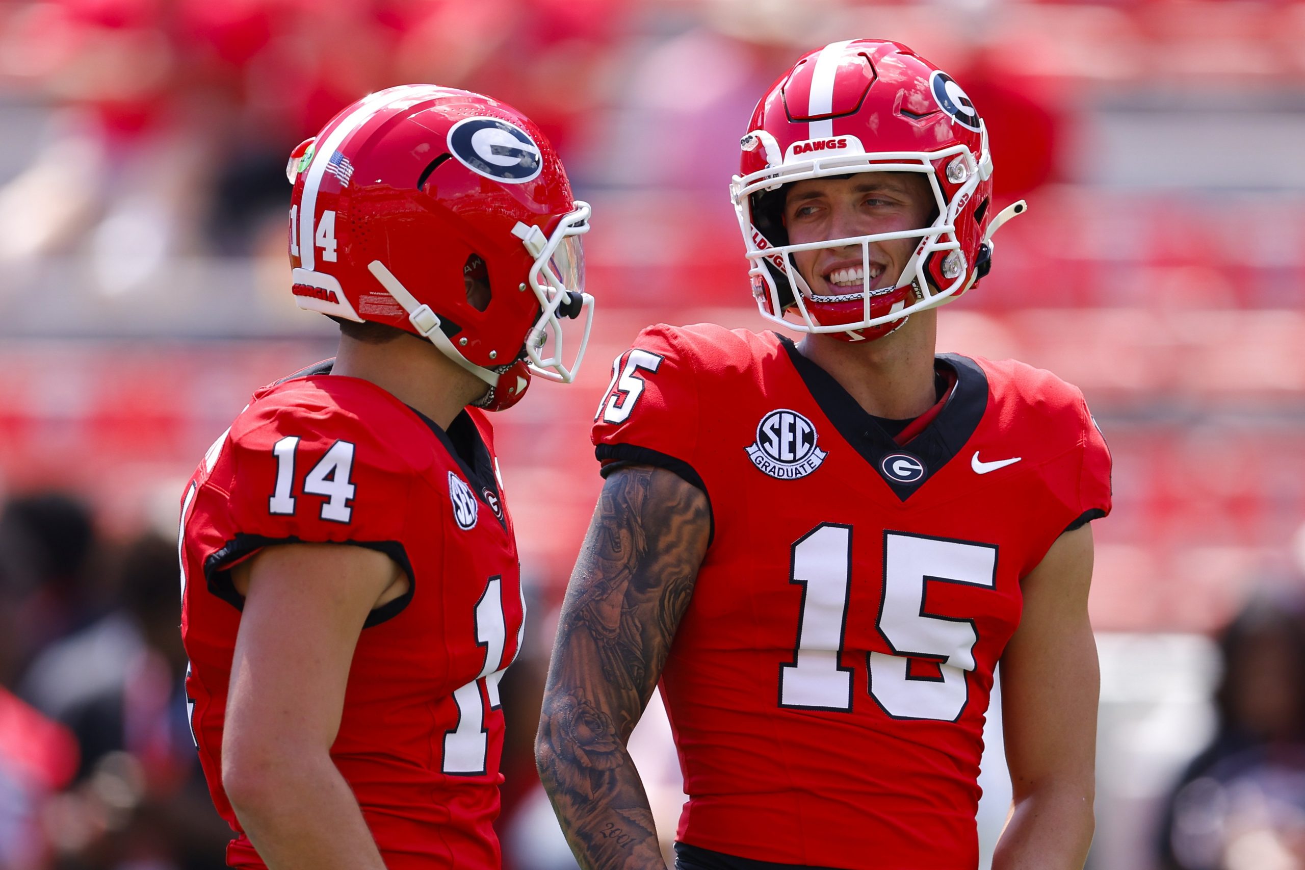 Carson Beck #15 speaks with Gunner Stockton #14 of the Georgia Bulldogs prior to the game against the Tennessee Tech Golden Eagles at Sanford Stadium on Sept. 7, 2024, in Athens, Georgia.