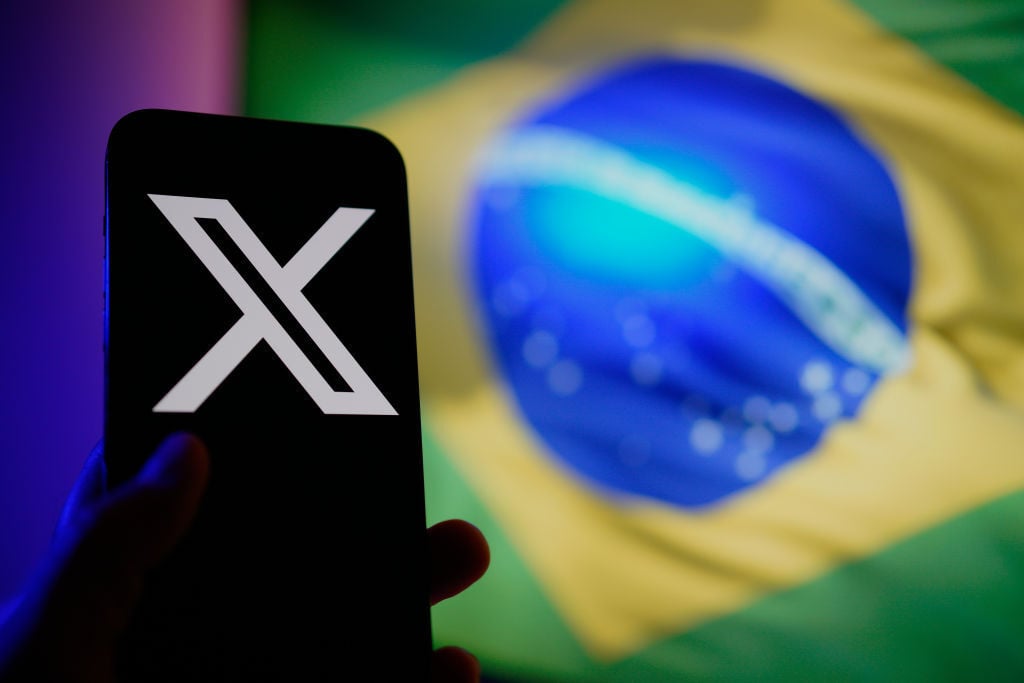 The Brazilian flag is seen reflected on a phone screen with the X logo in this illustration photo taken in Warsaw, Poland on 01 Septemnber, 2024.