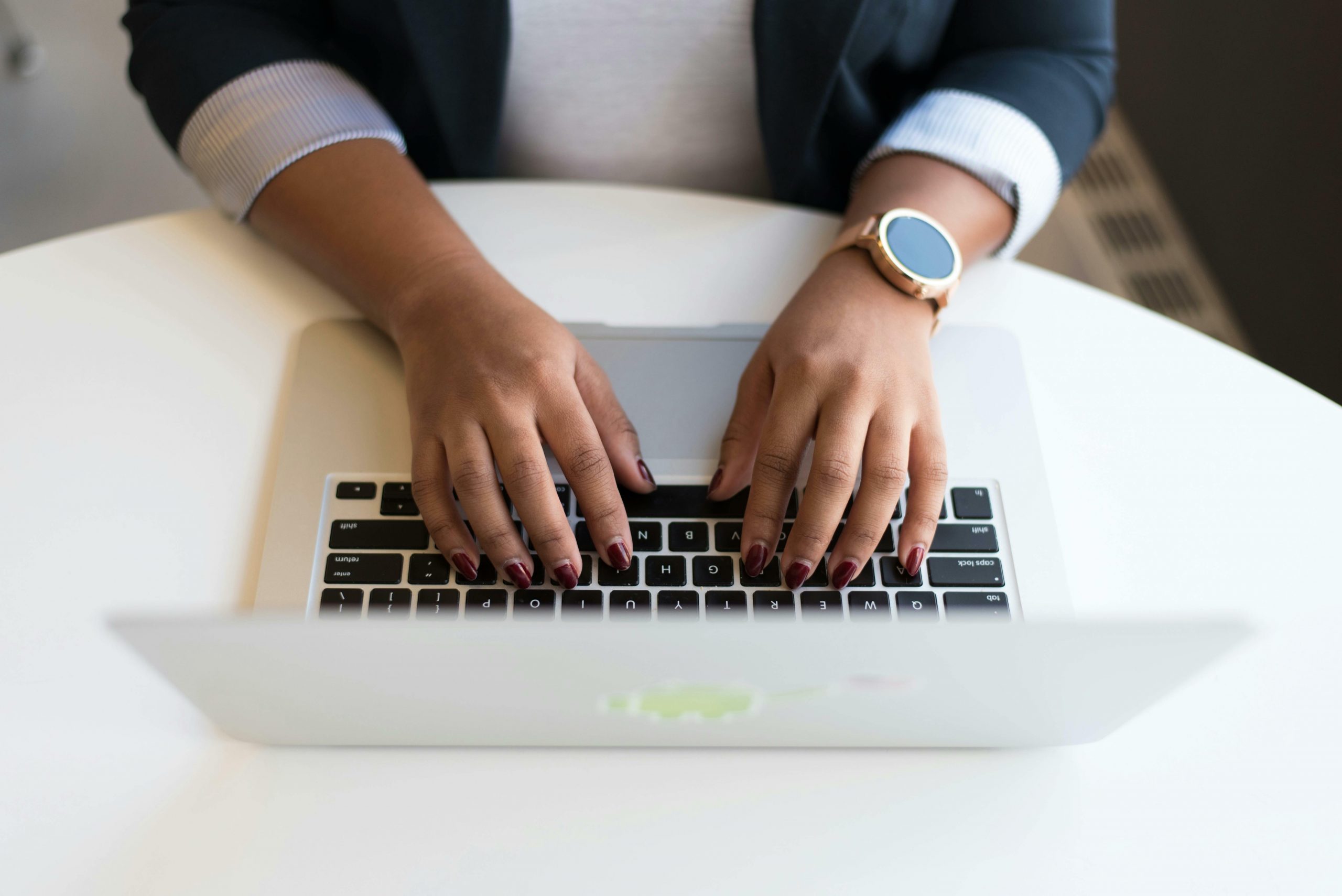 Aerial view of person typing on a laptop.