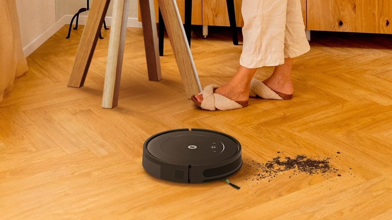 Roomba vacuum cleaning up a mess in a kitchen