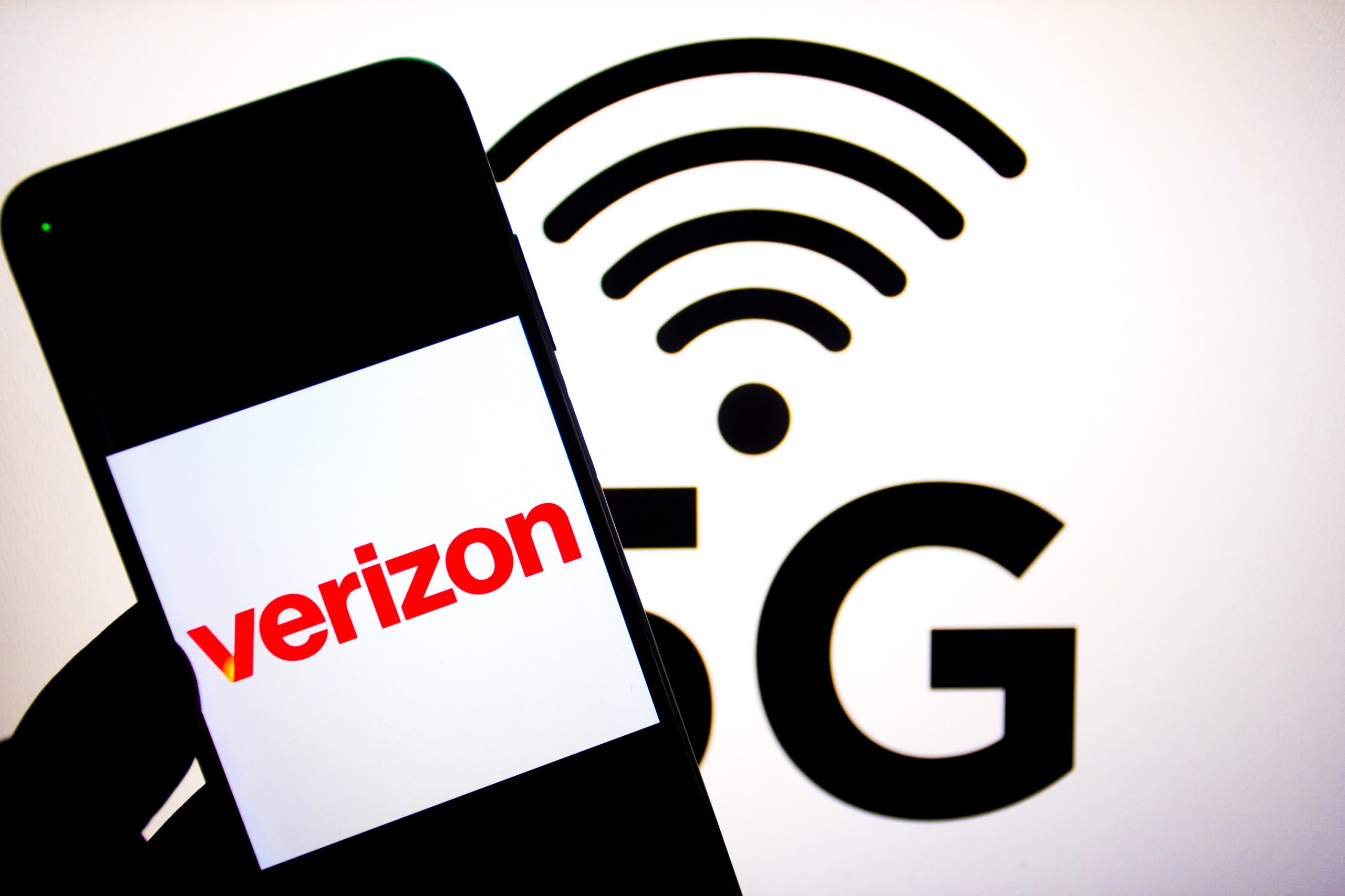 verizon logo on a phone with wifi symbol and 5g behind it.