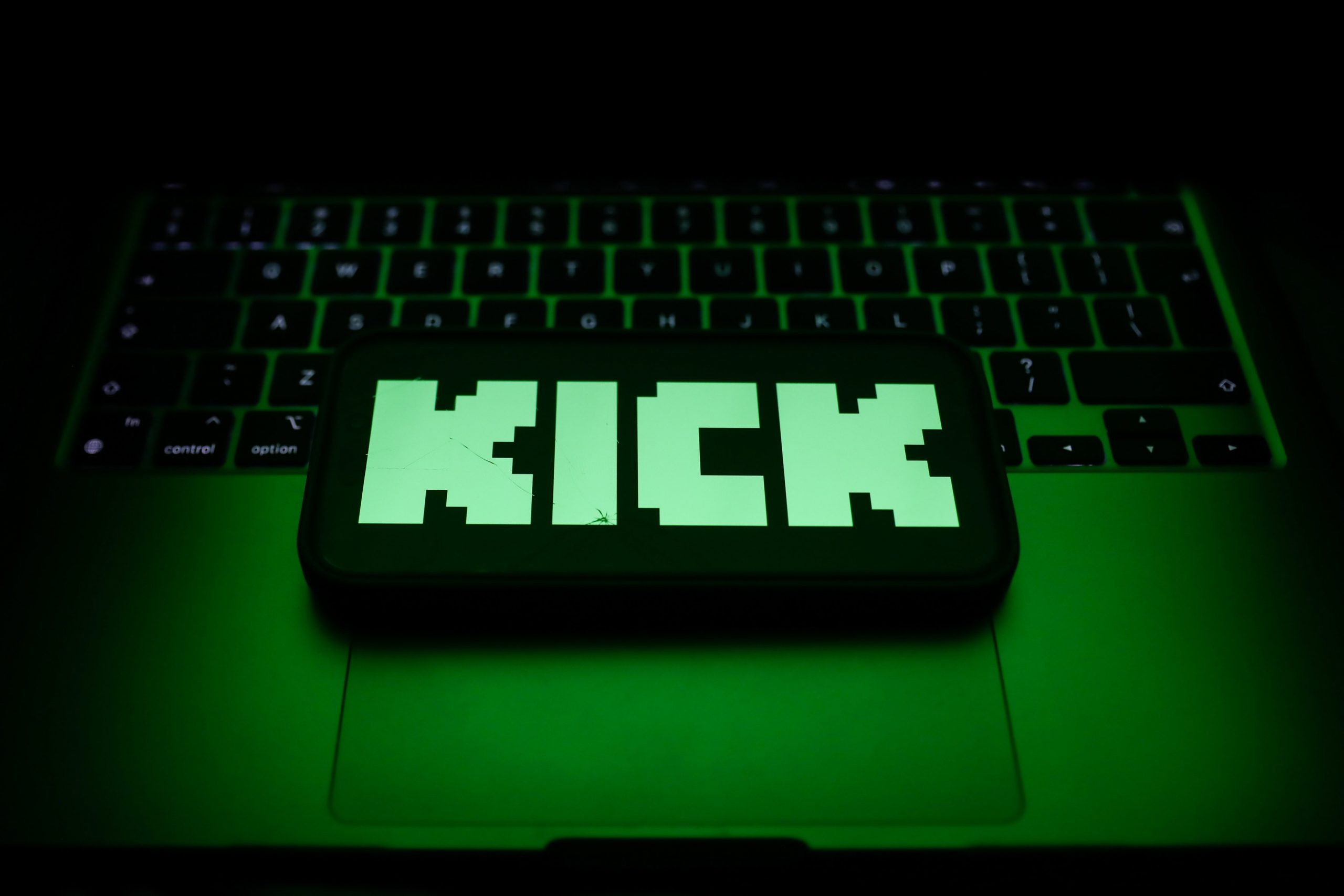 A laptop keyboard and Kick logo