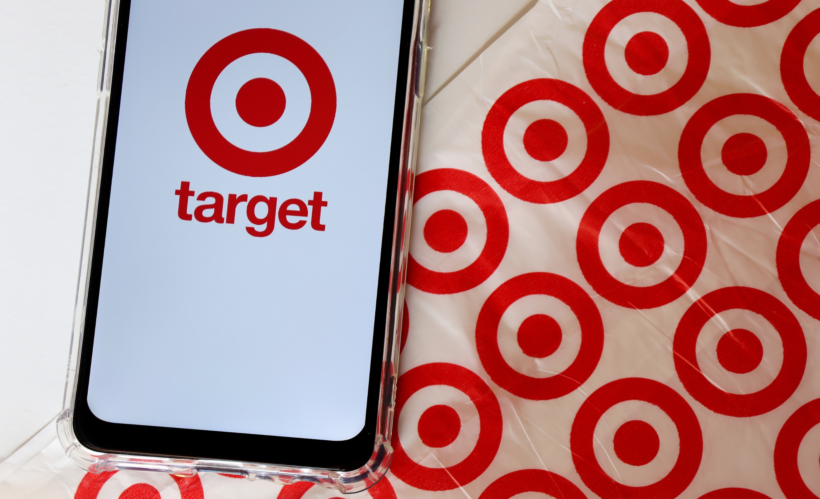 Bahia, Brazil - September 30, 2020.  Target Store logo on smartphone screen on top of Target shopping bag. Hypermarket. 