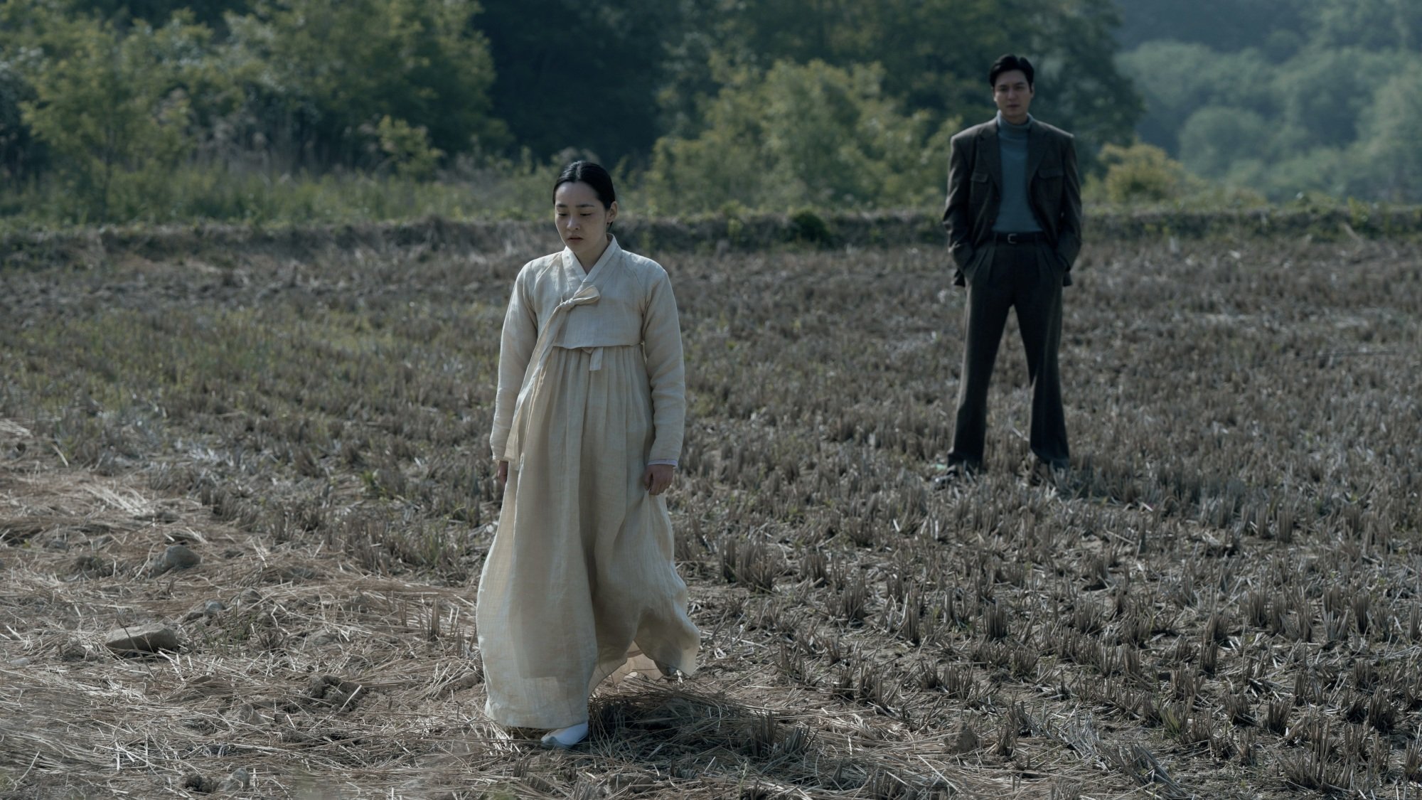 Sunja and Hansu have a conversation in a rice field in winter.