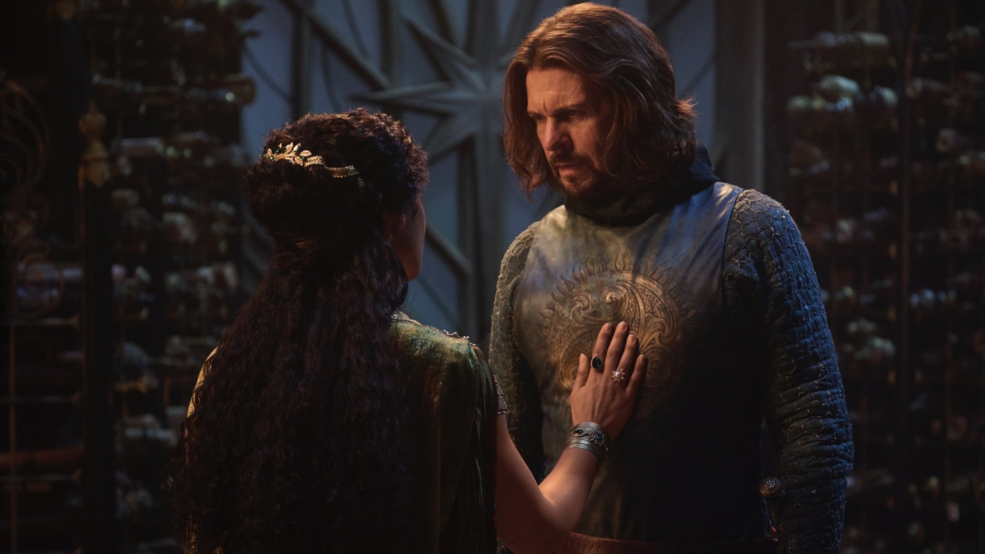 Míriel puts her hand on Elendil's chest.