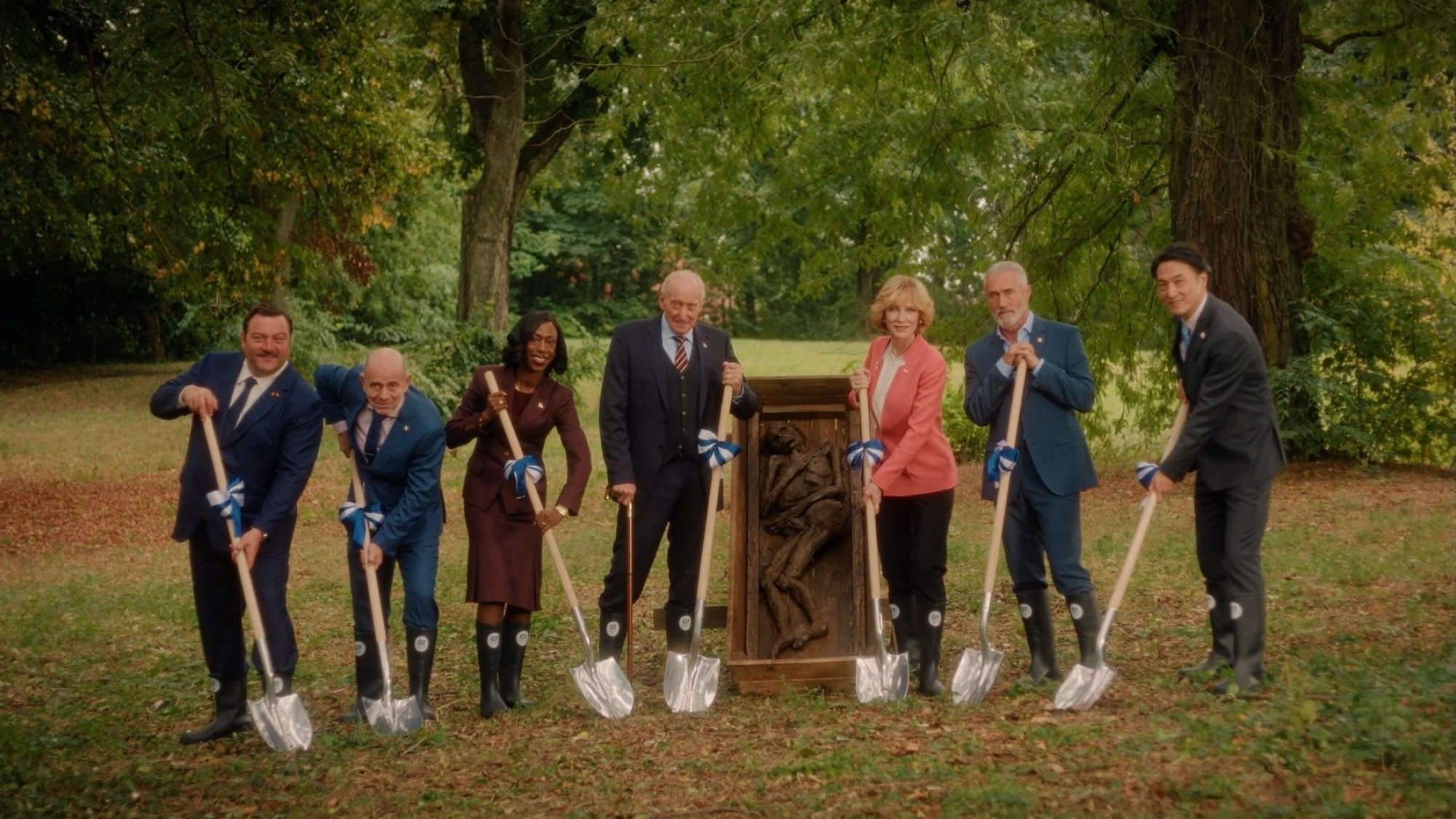 Denis Ménochet, Rolando Ravello, Nikki Amuka-Bird, Charles Dance, Cate Blanchett, Roy Dupuis, and Takehiro Hira pose with shovels in "Rumours."