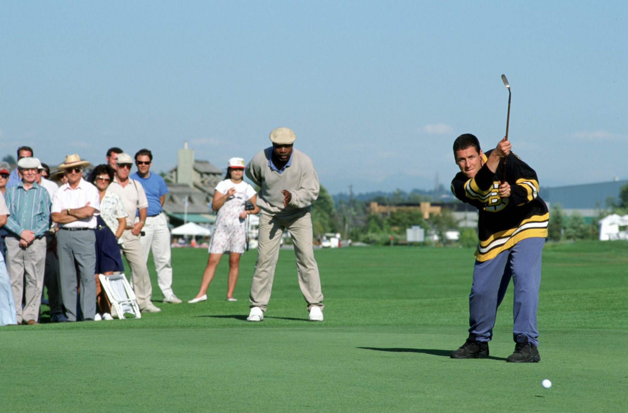 Carl Weathers watches Adam Sandler take a golf hit in the movie "Happy Gilmore"