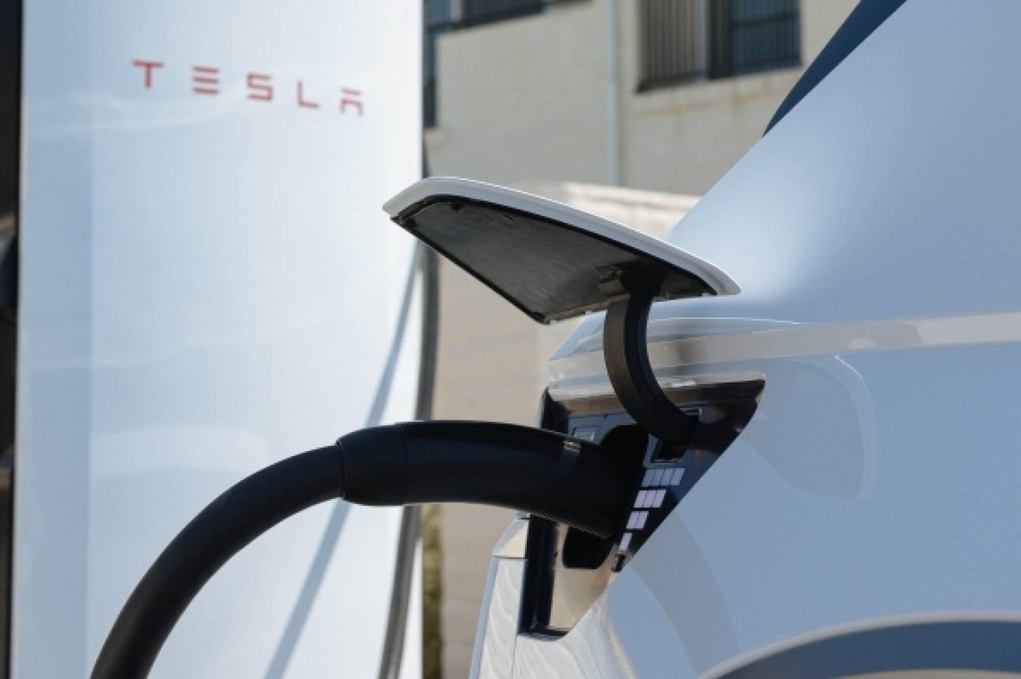 Hyundai charging at a Tesla Supercharger port.