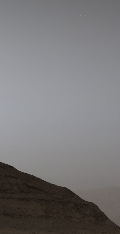 The moon Phobos and Earth seen in the upper right. 