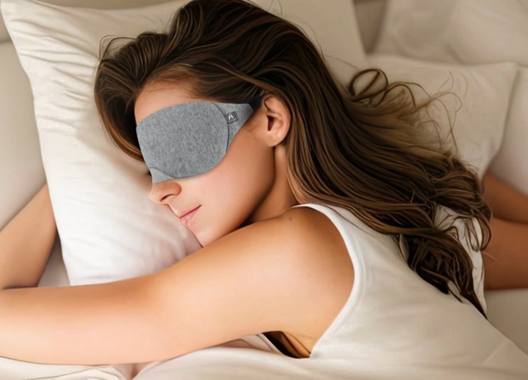 woman wearing sleeping mask in bed