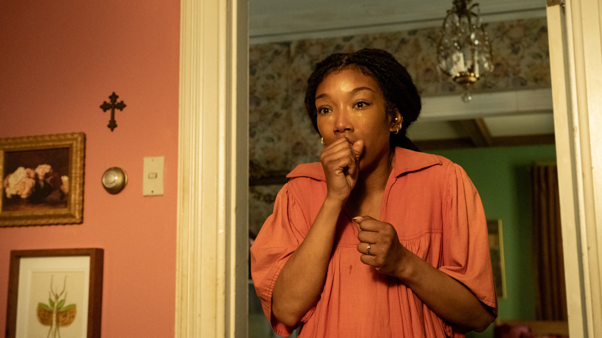 Brandy Norwood stands in shock with tears in her eyes in "The Front Room"