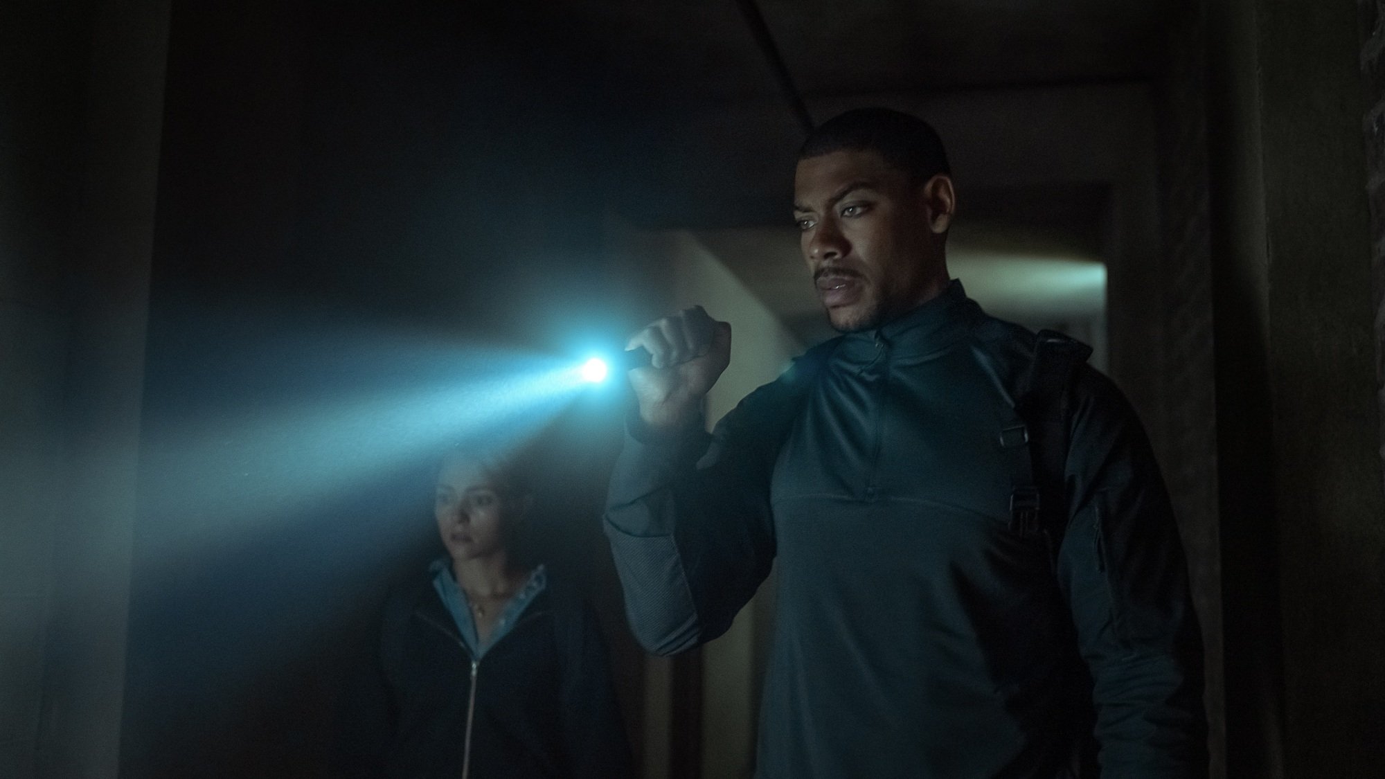 Terry Richmond shines a light through a dark room as he and Summer McBride investigate.