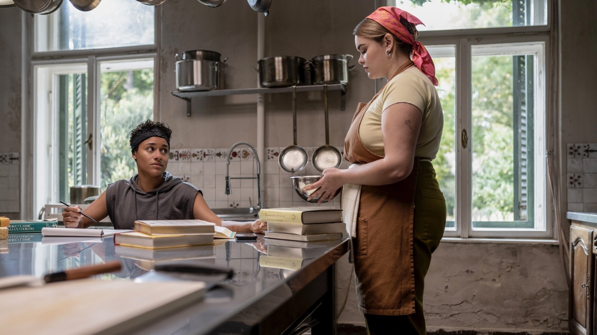 Chef and Lucia working in a restaurant kitchen.