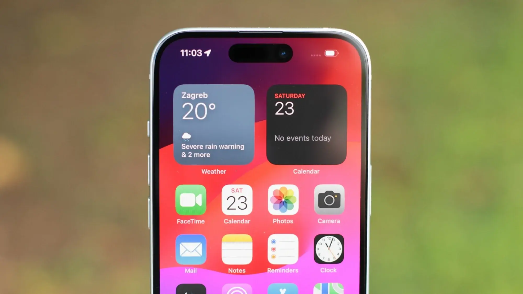 Apple iPhone 15 front display showing home screen