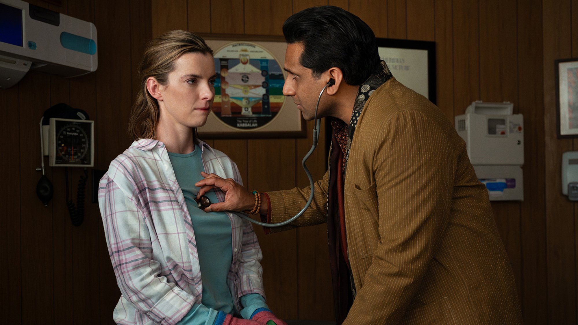 Betty Gilpin as Lina in "Three Women," having her heart rate measured by a doctor.