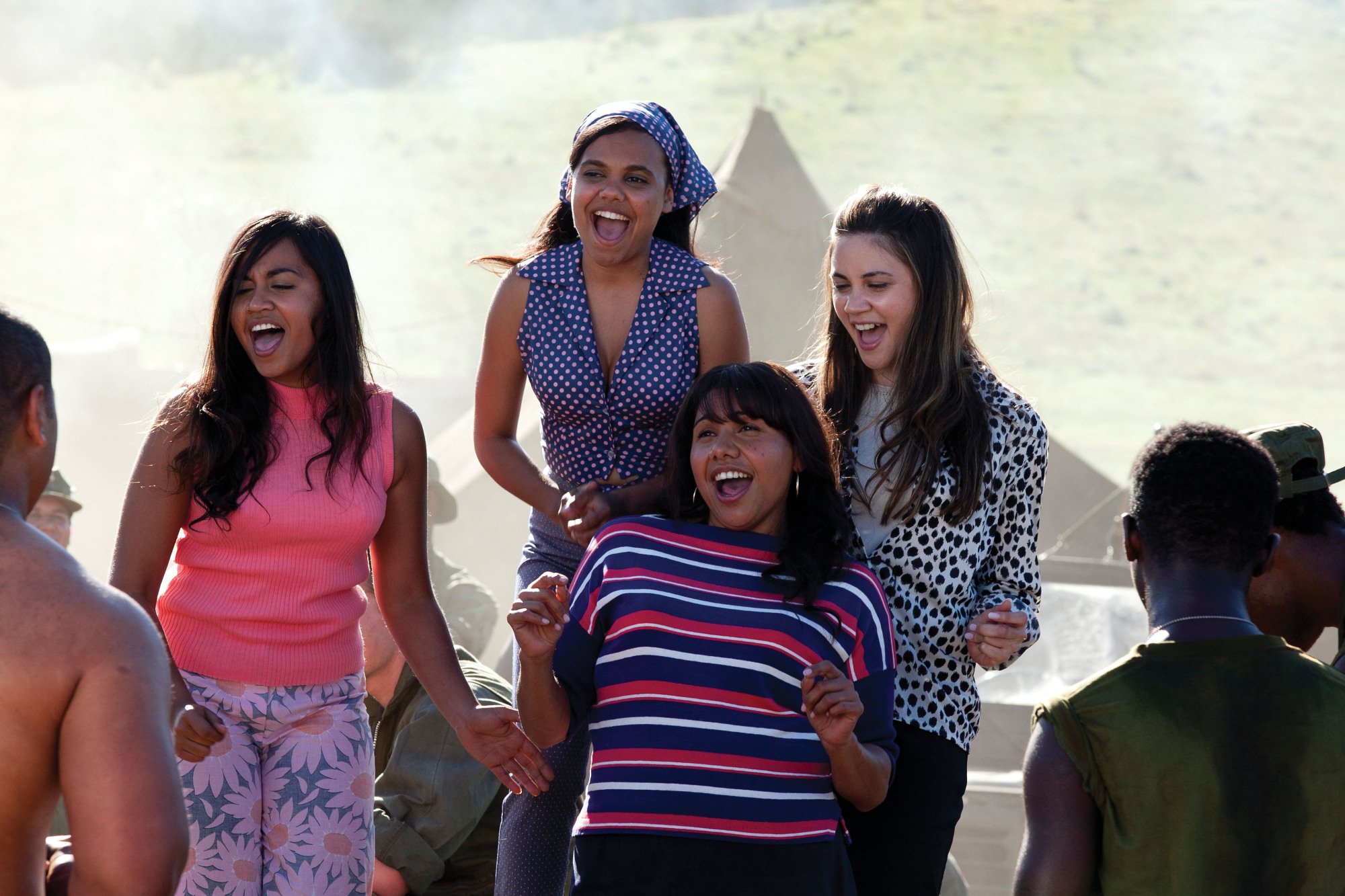 The Sapphires, four Australian First Nations young women, laughing.