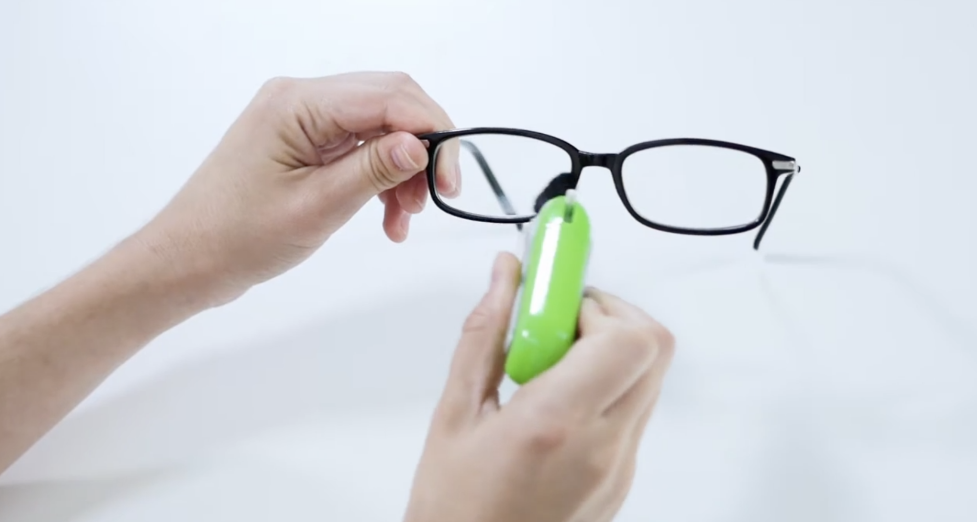 person cleaning glasses