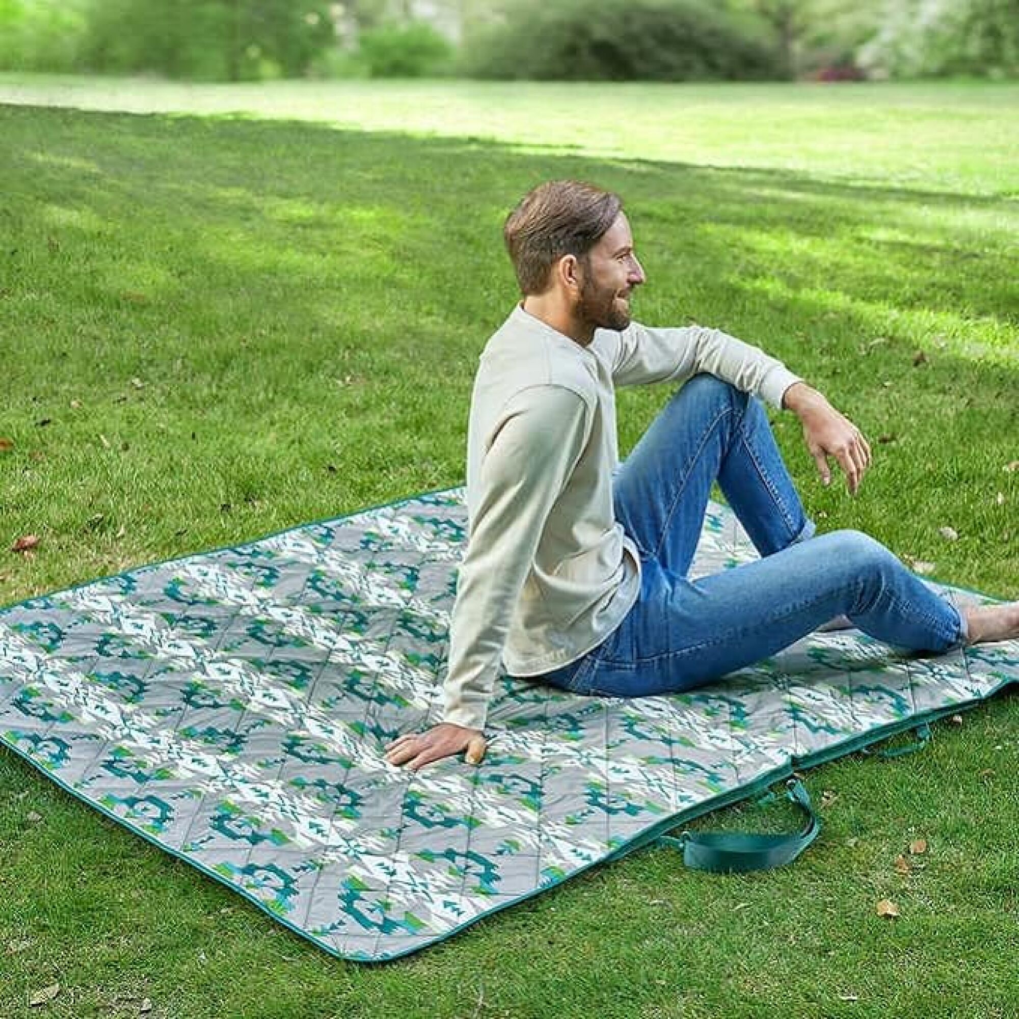 man sitting on blanket outdoors