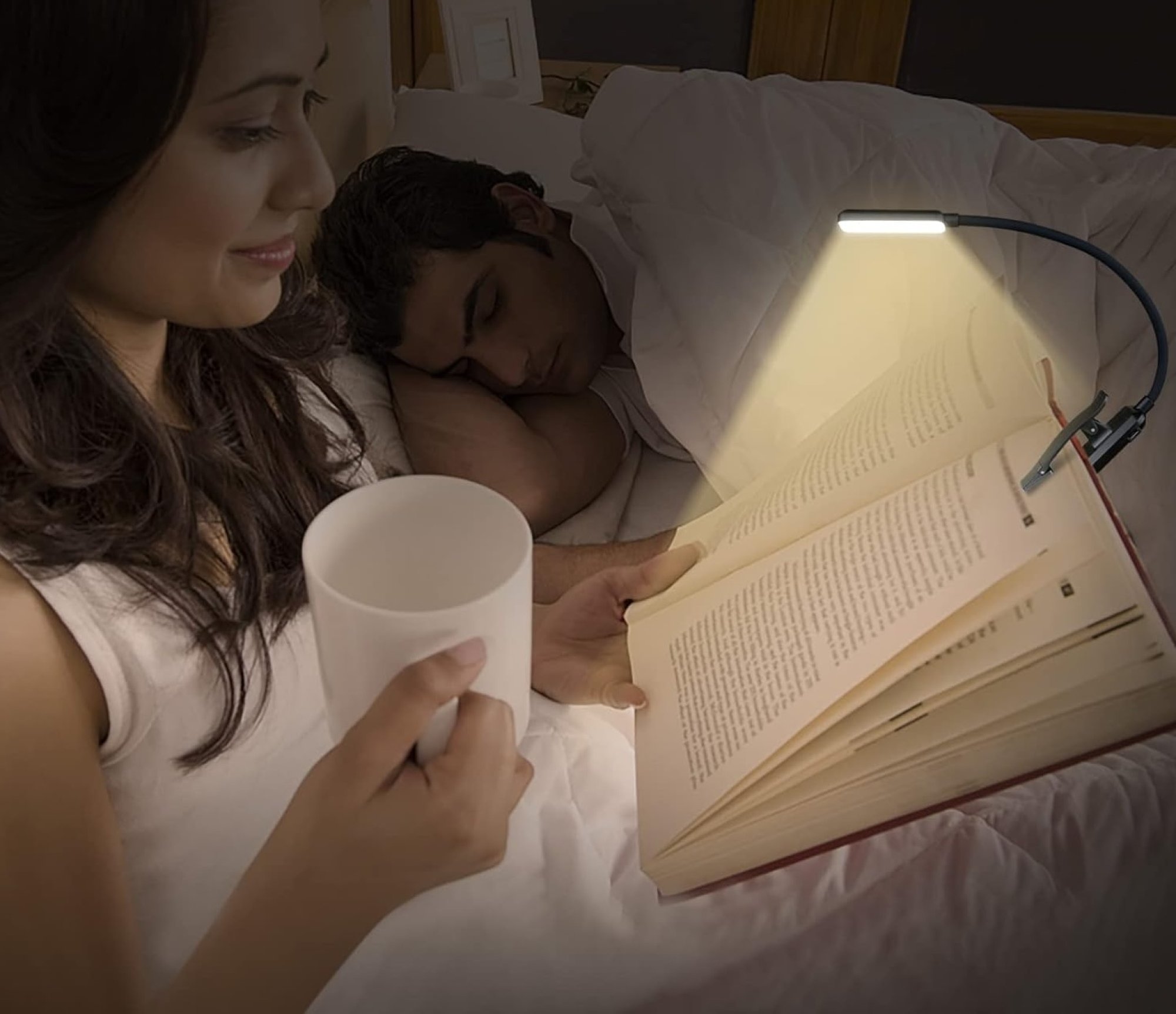 woman reading a book with book light