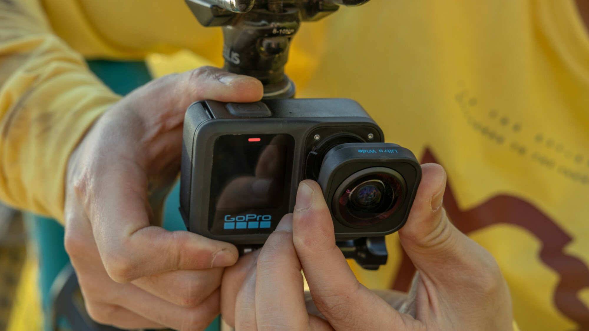 A person removing the Ultra Wide Lens from the GoPro HERO13 Black.