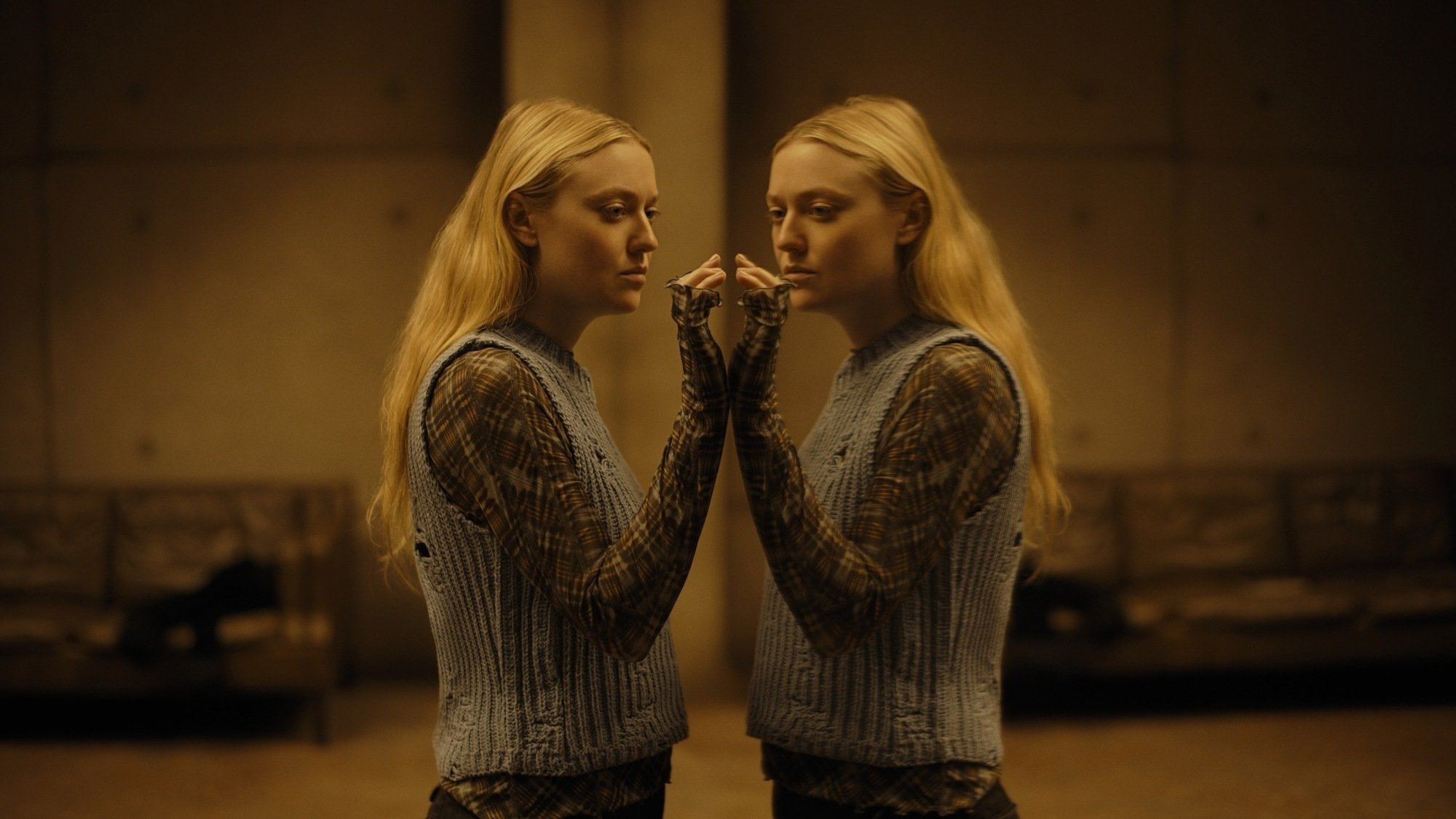 dakota fanning stares at her reflection in still from 'the watchers' movie