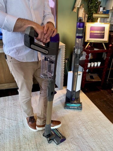 man holding shark powerdetect cordless stick vacuum