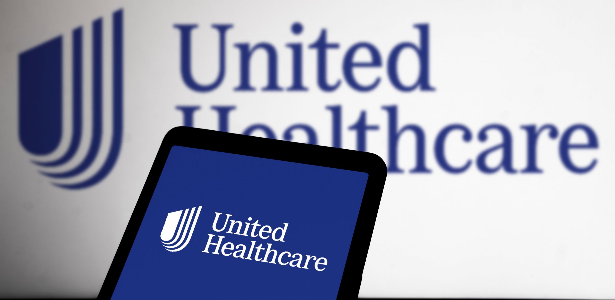 UnitedHealthcare logo in the background and on a phone