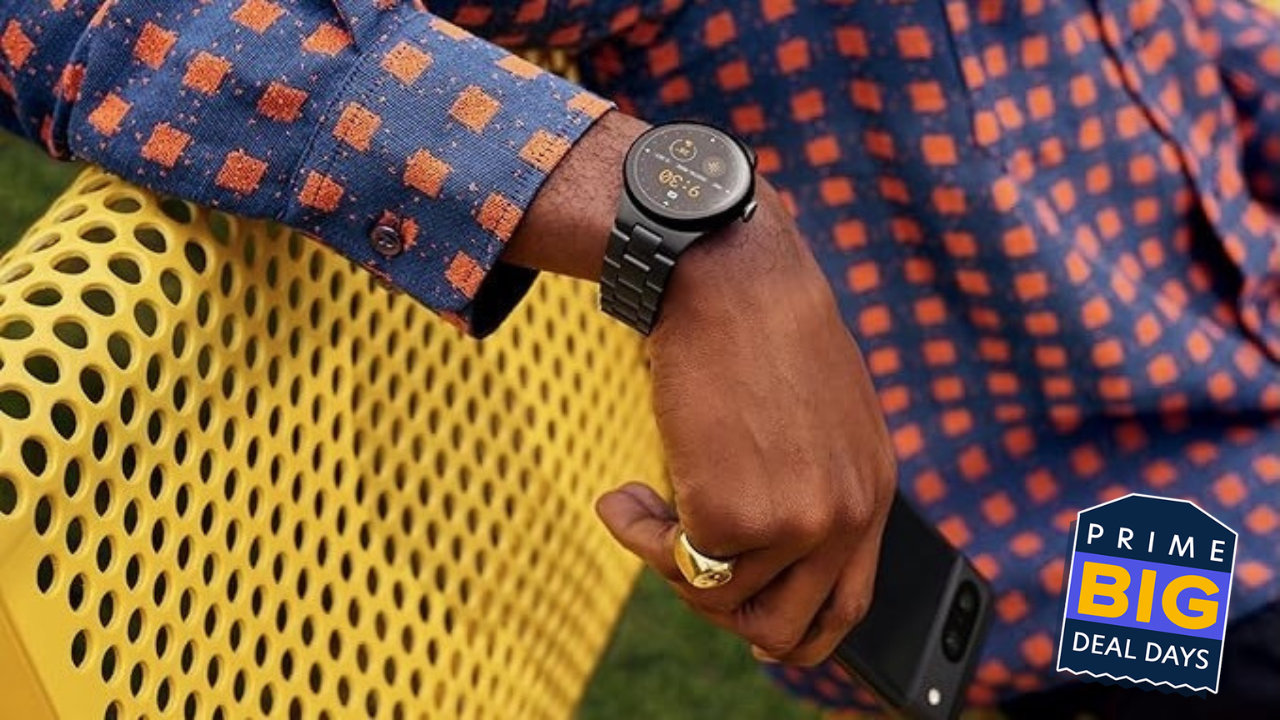 pixel watch 2 on a wrist of a person sitting on a yellow bench