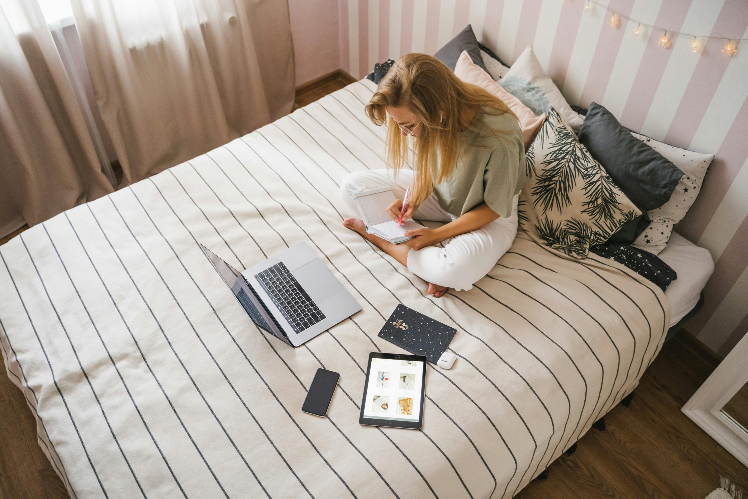 Girl with laptop on bed