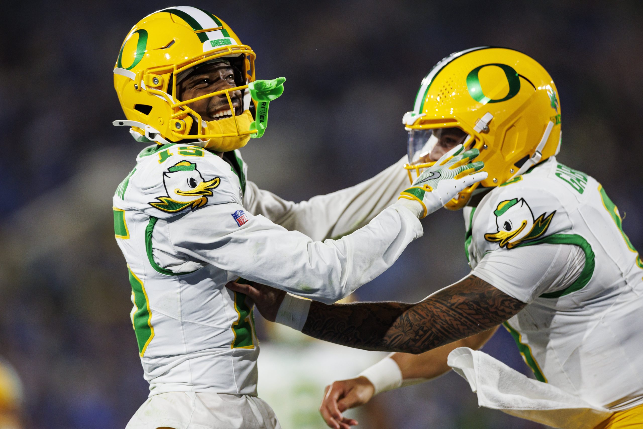 Wide receiver Tez Johnson #15 of the Oregon Ducks celebrates with quarterback Dillon Gabriel #8 after scoring a touchdown during the second quarter of an NCAA college football game against the UCLA Bruins, at Rose Bowl on Sept. 28, 2024, in Pasadena, California.