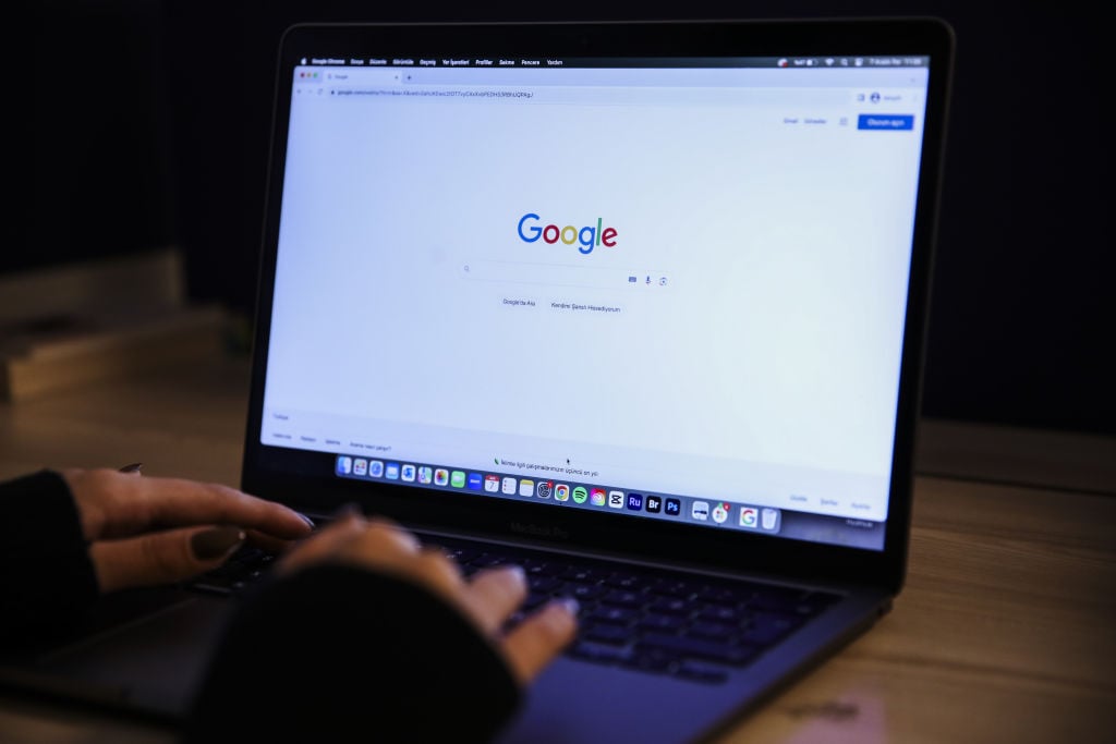 A laptop screen displays the Google search page